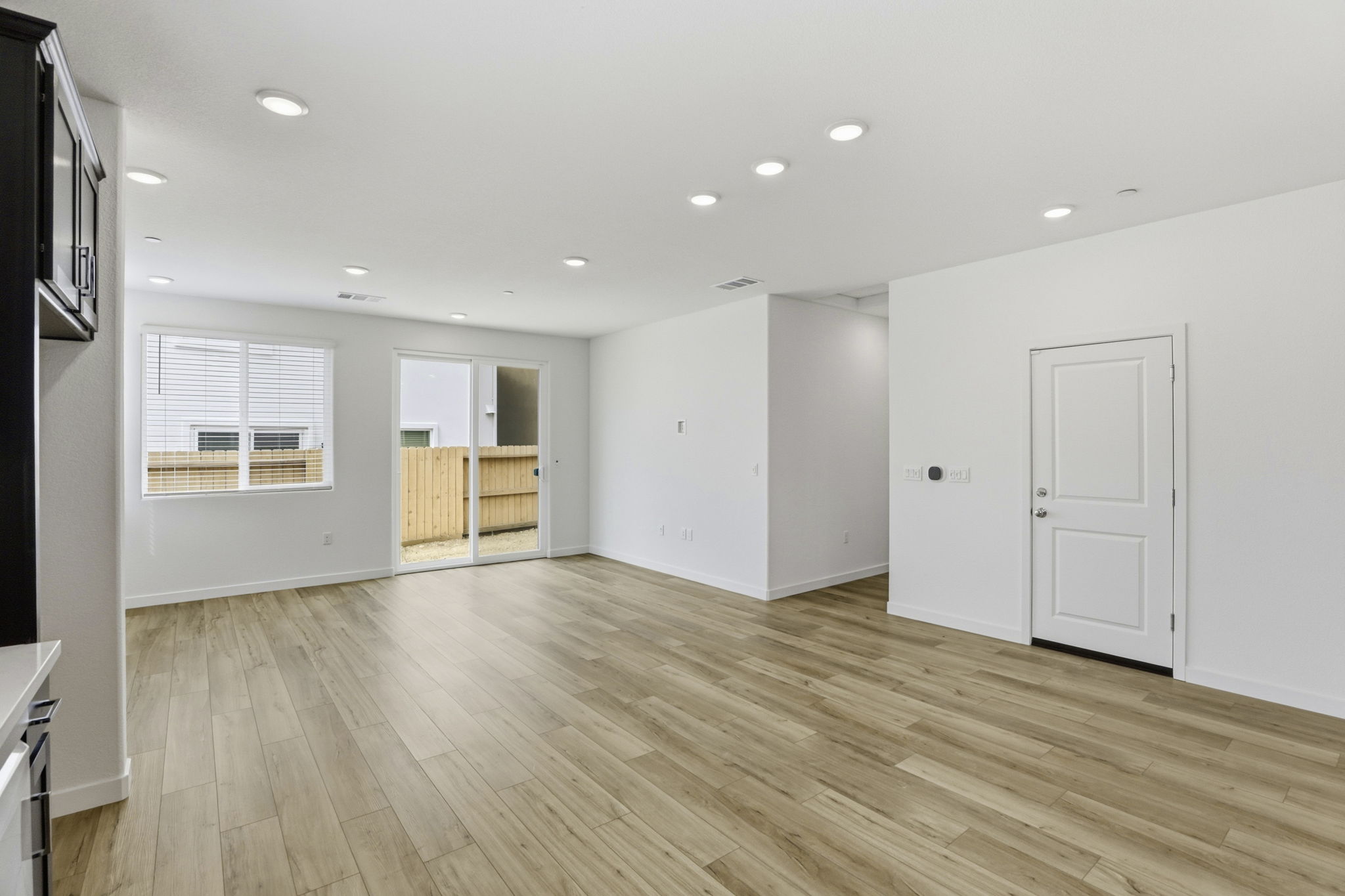 A room with white walls and a wood floor.