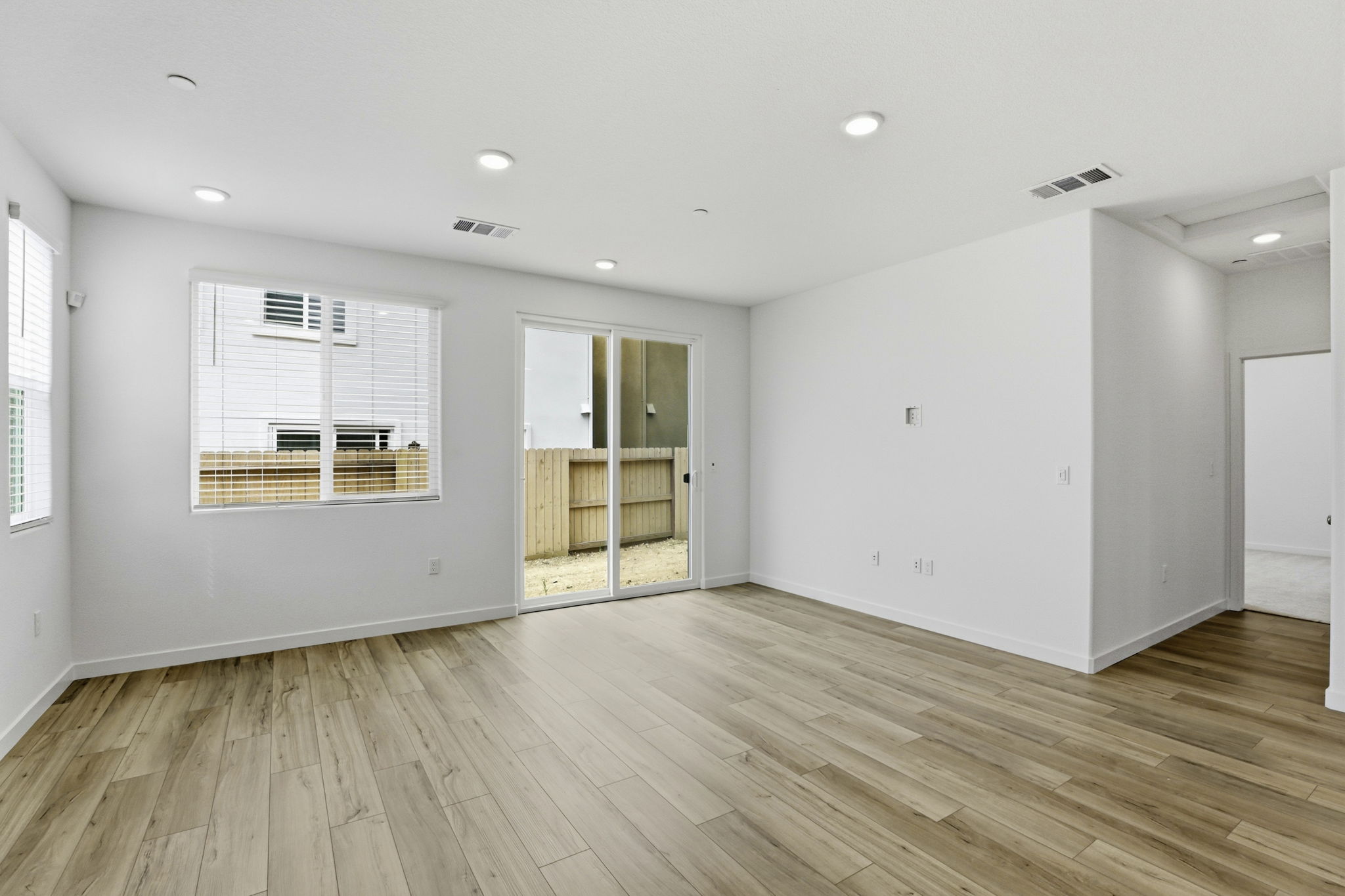 A room with a wood floor and white walls.