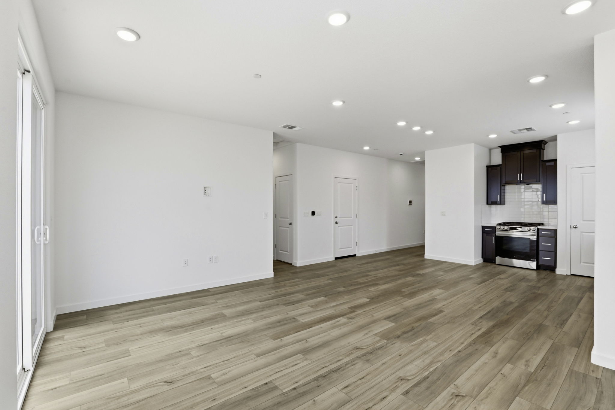 A room with white walls and wood floors.