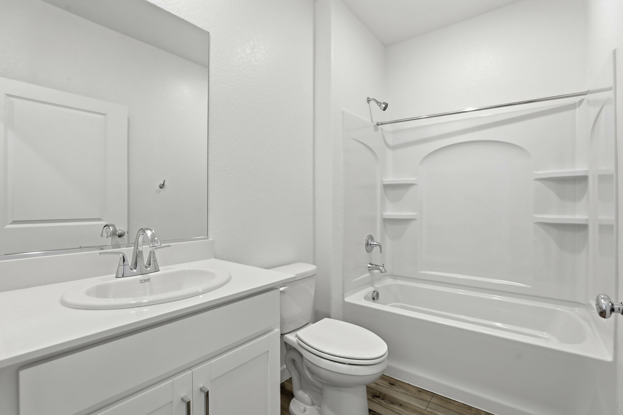 A bathroom with a tub sink and toilet.