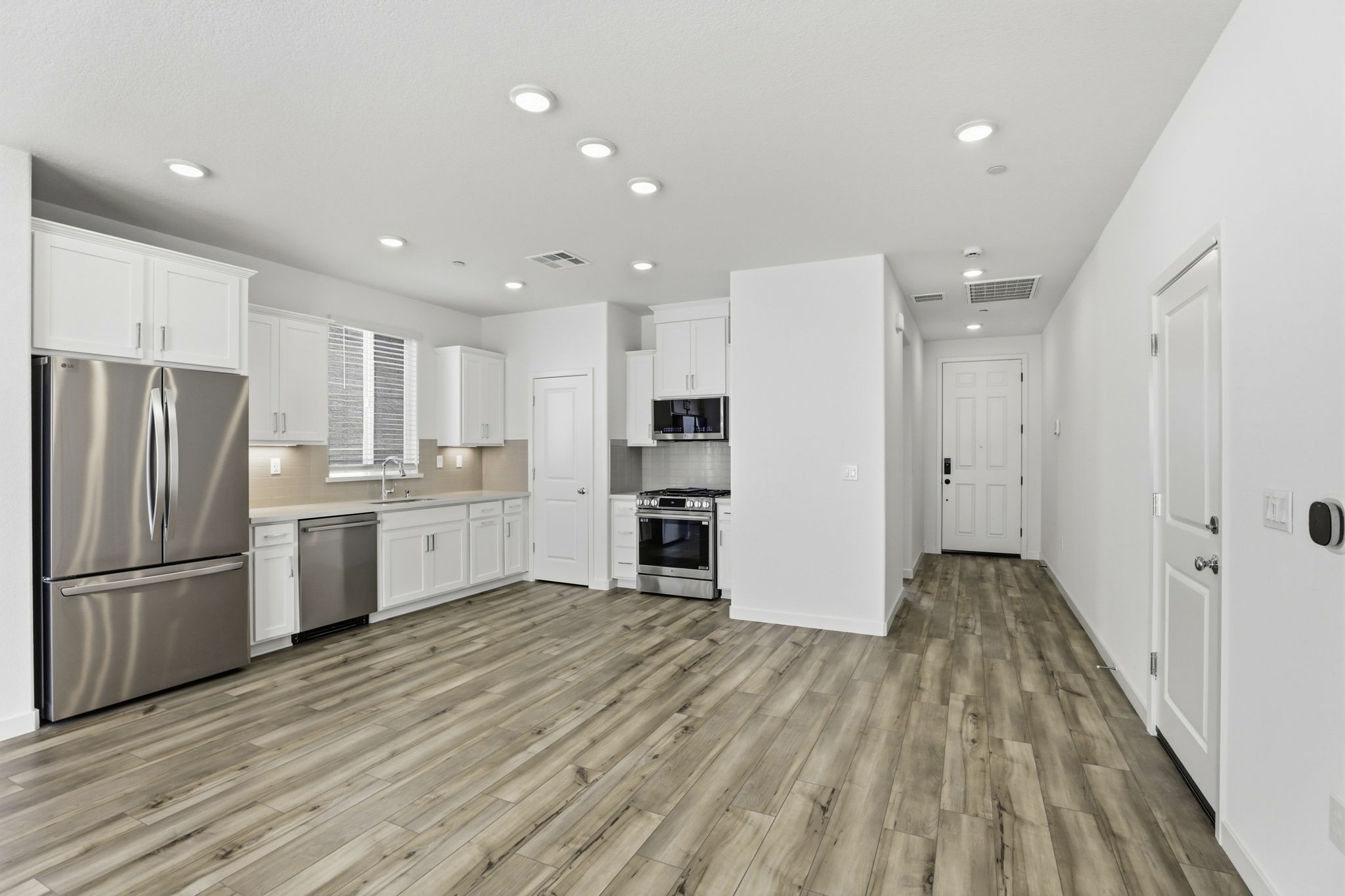 A kitchen with white cabinets.