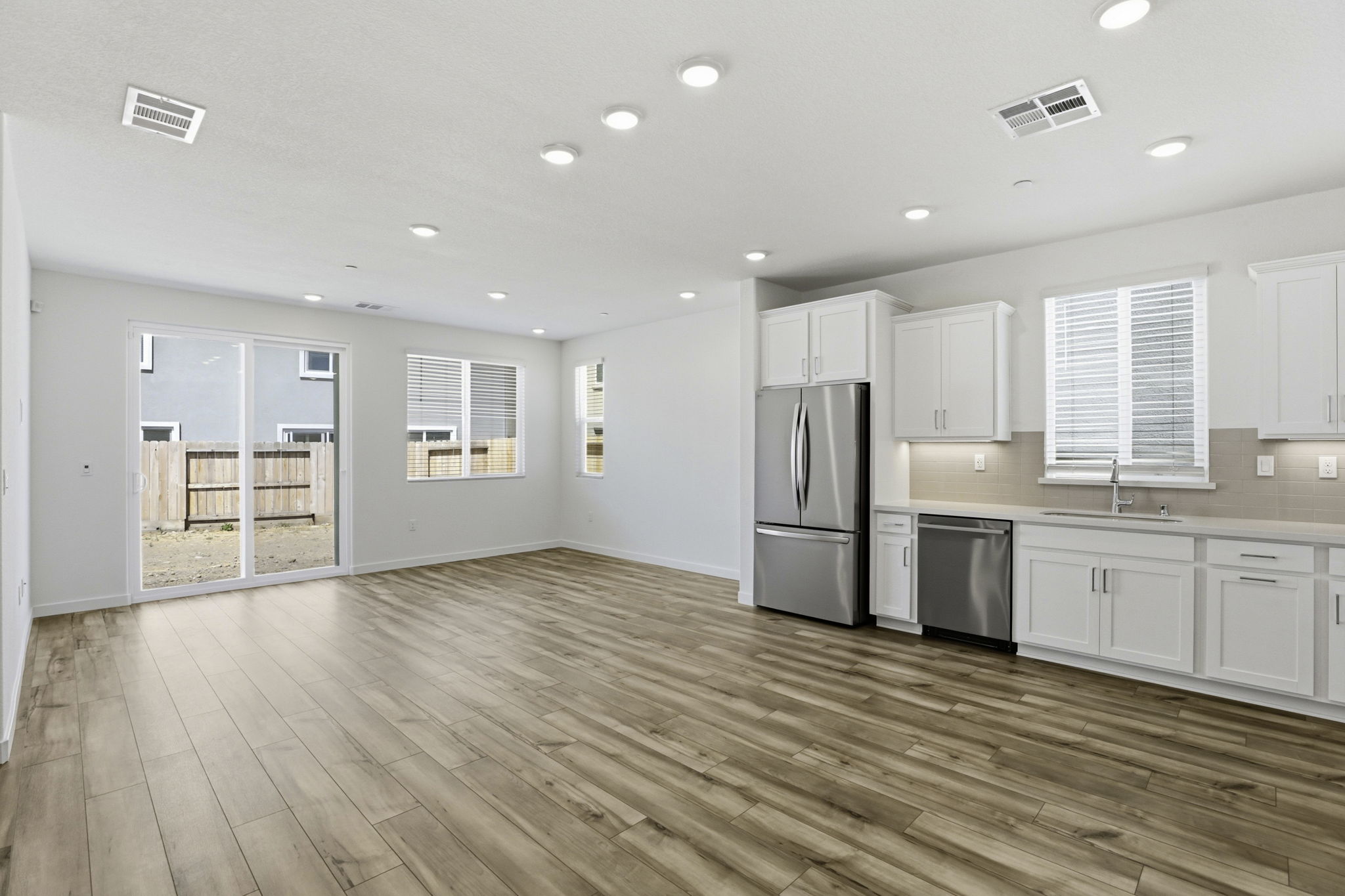 A kitchen with white cabinets.
