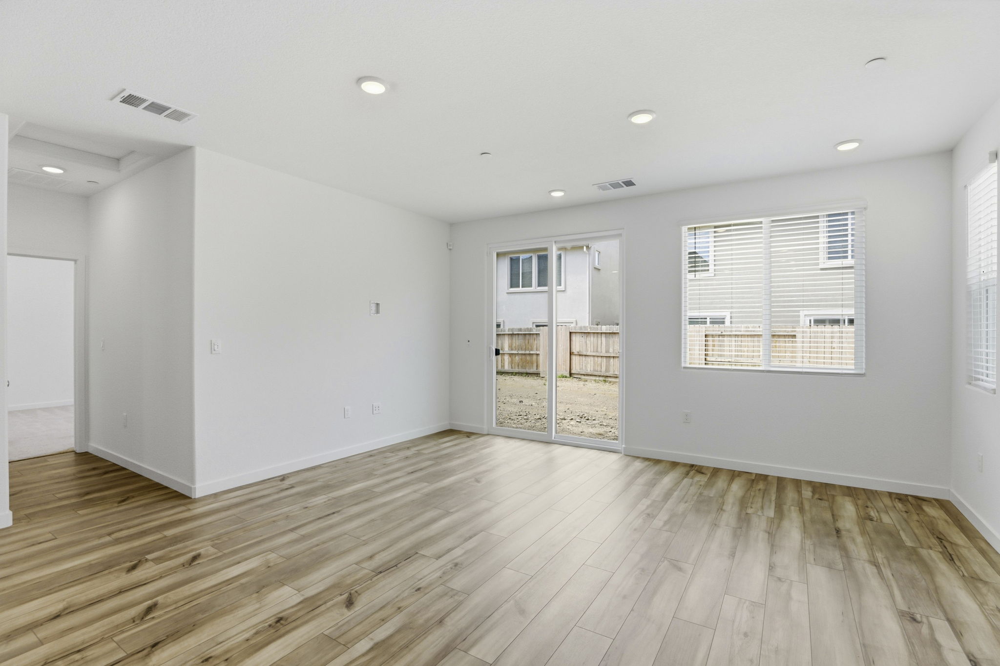 A room with a wood floor and white walls.
