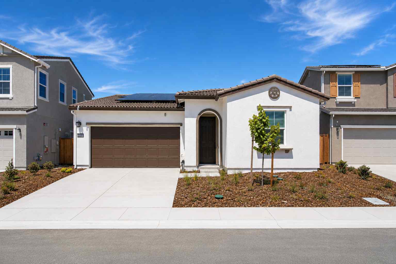 A white house with a garage.