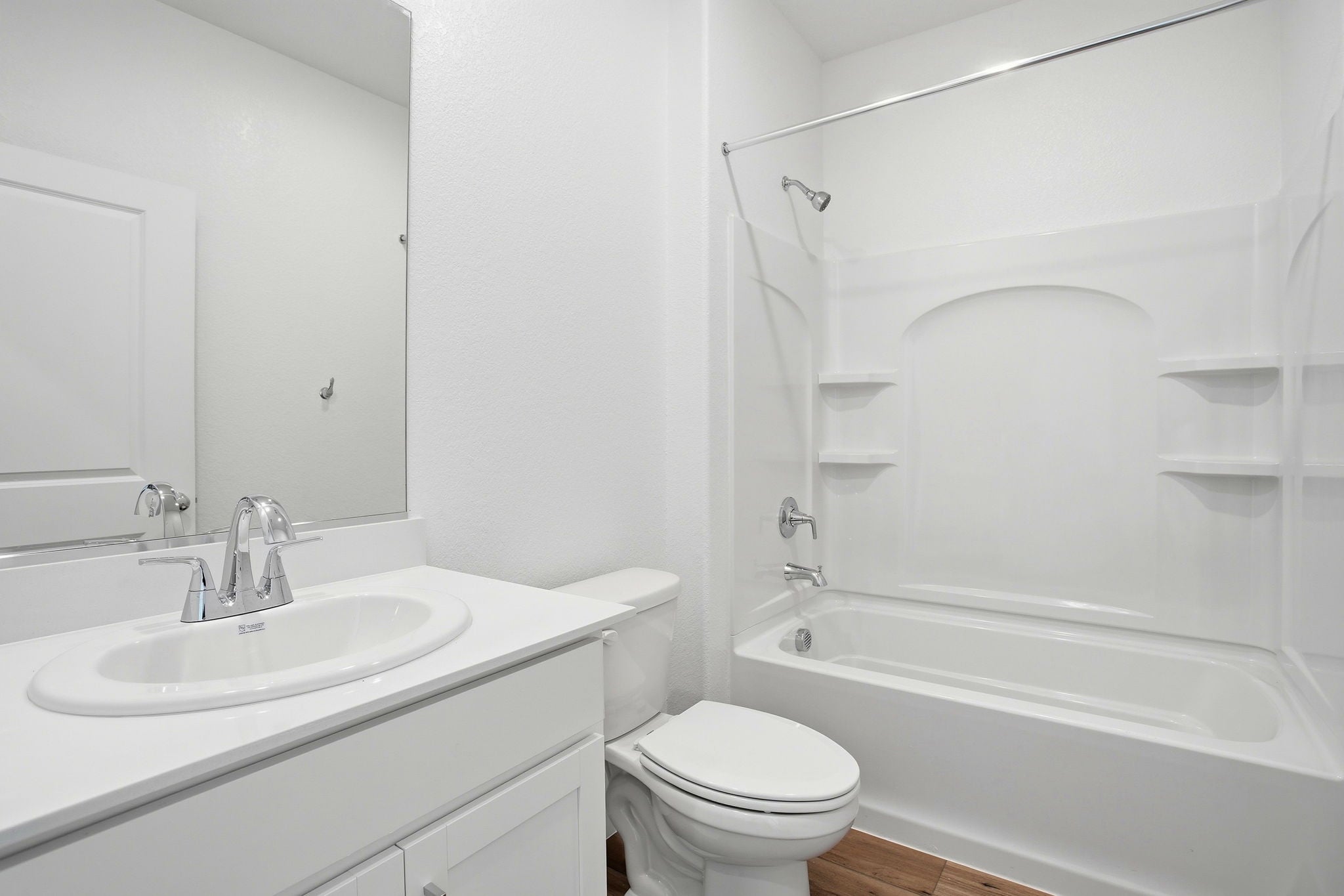 A bathroom with a tub sink and toilet.