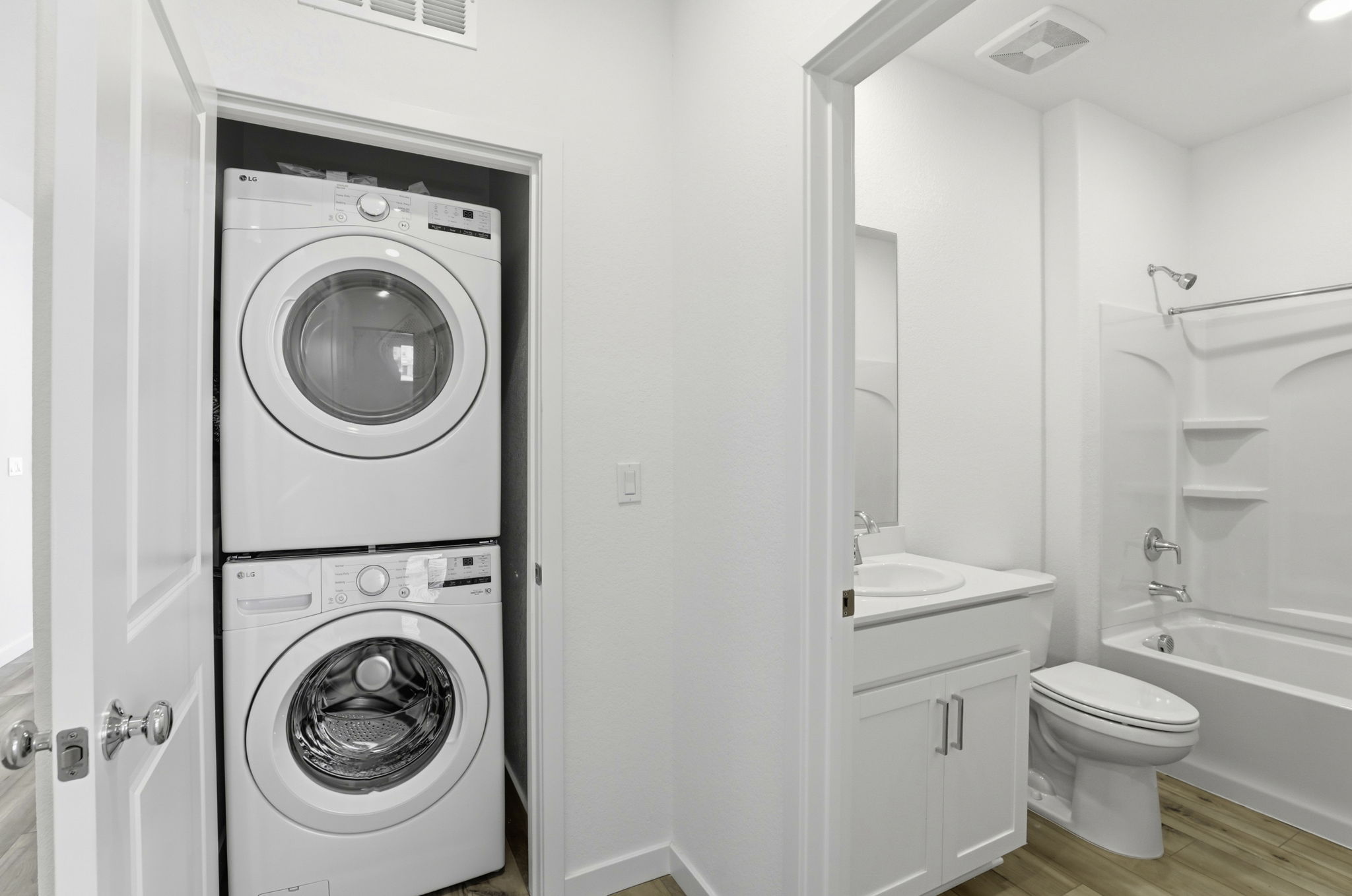 A bathroom with a washer and dryer.