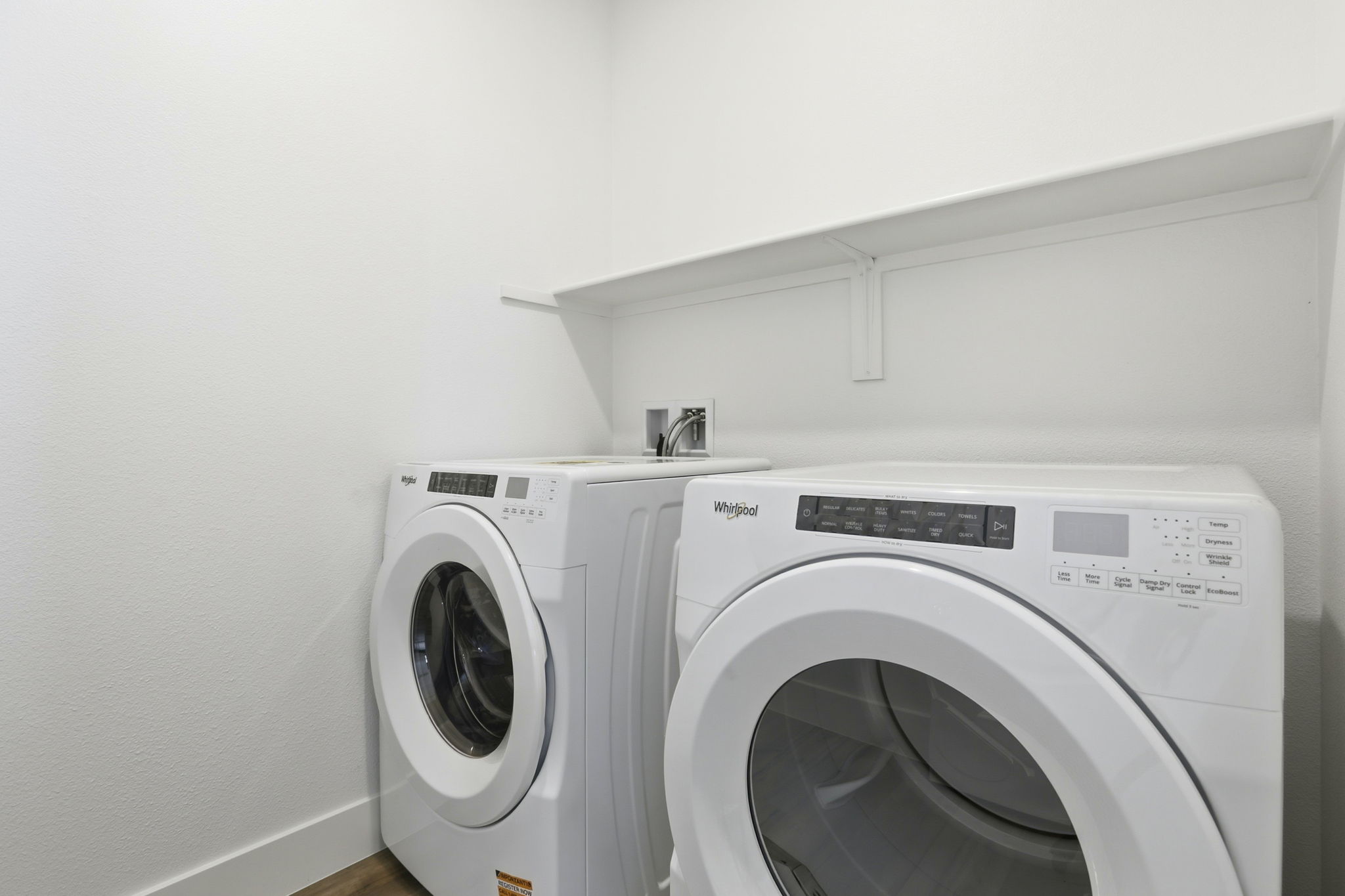 A washing machine in a room.