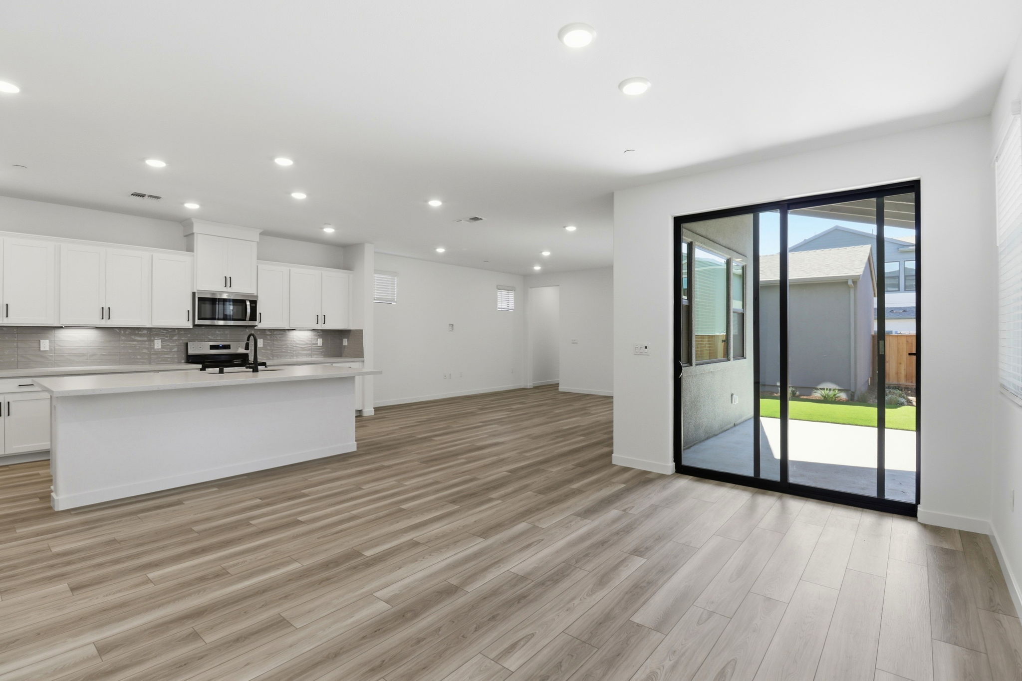 A large kitchen with white cabinets.