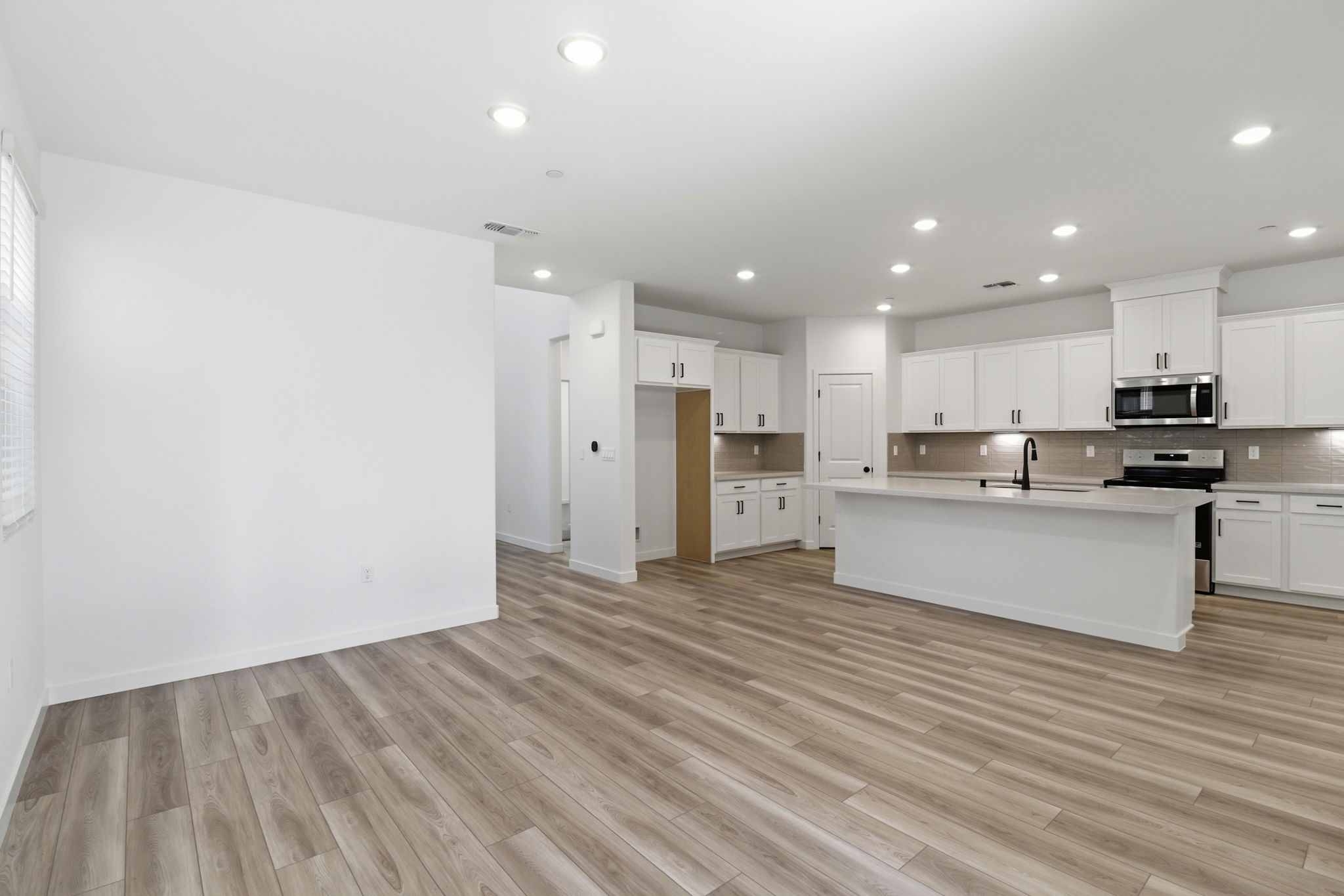 A large kitchen with white cabinets.