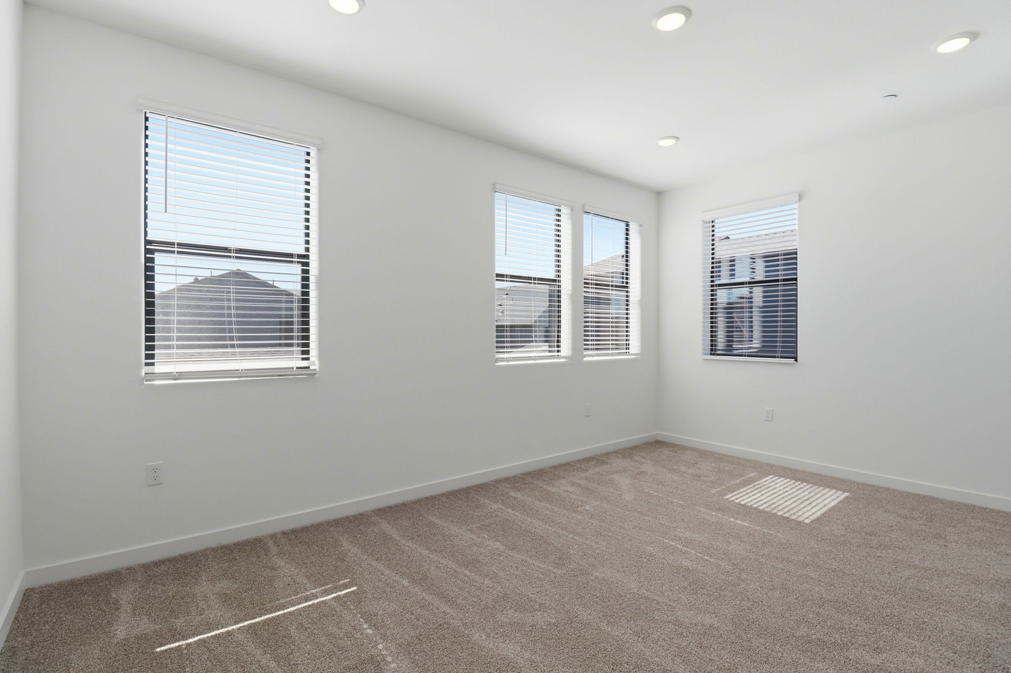 A room with a window and blinds.