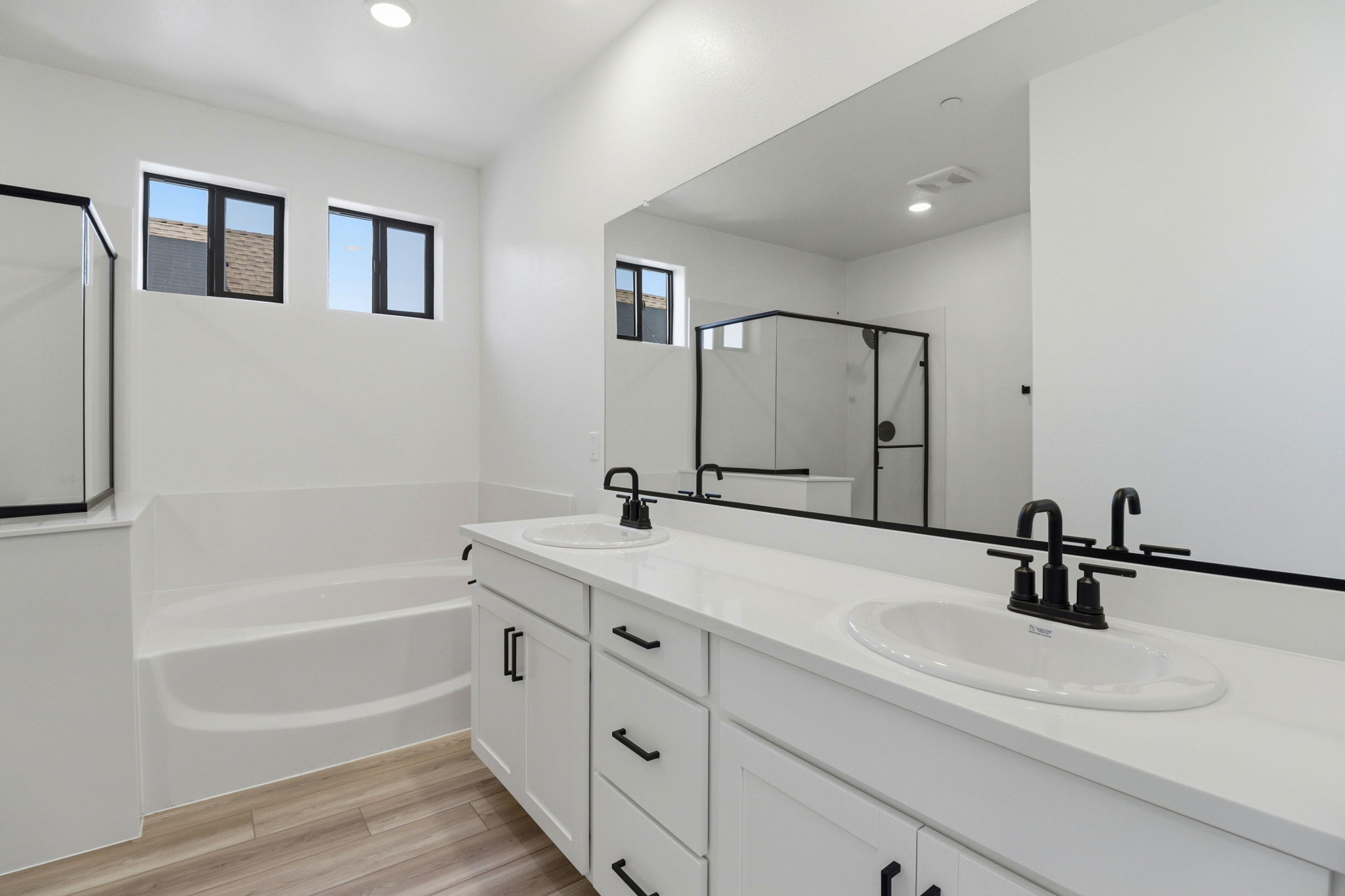 A bathroom with a large mirror.