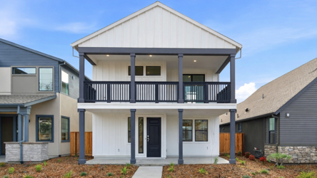 A house with a porch with Southfork Ranch in the background.