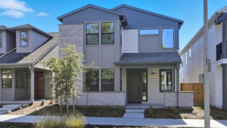 A house with a tree in the front.
