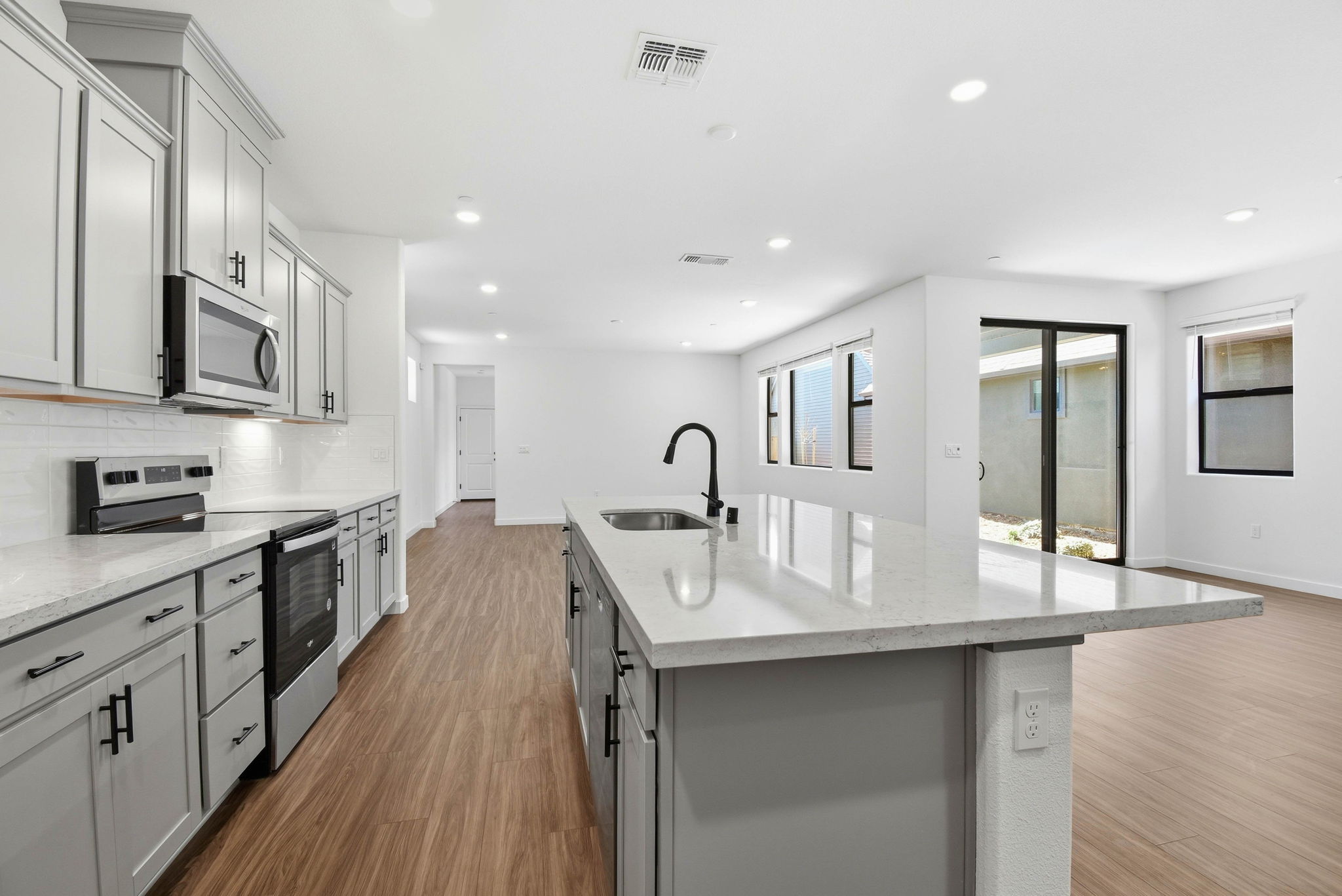 A kitchen with white cabinets.