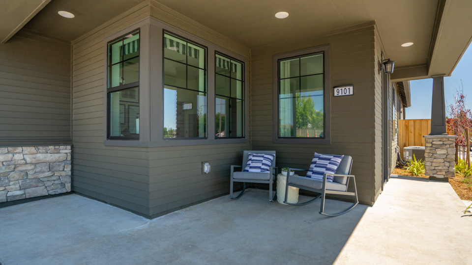 A house with a patio and a bench.