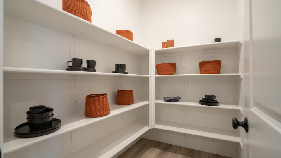 A white shelving unit with various objects on it.