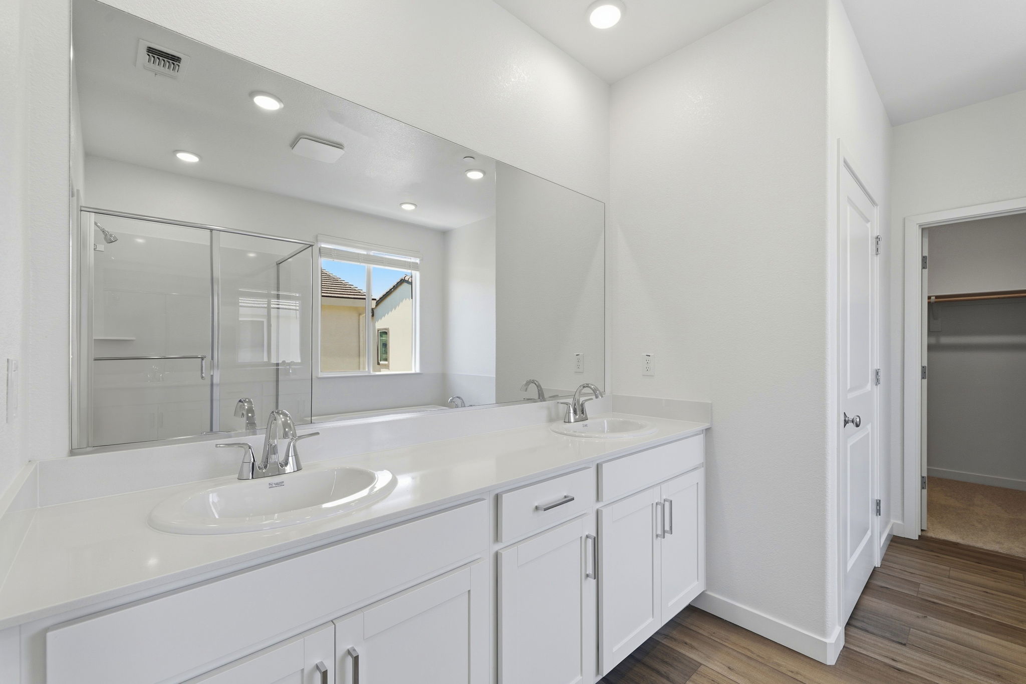 A bathroom with a large mirror.
