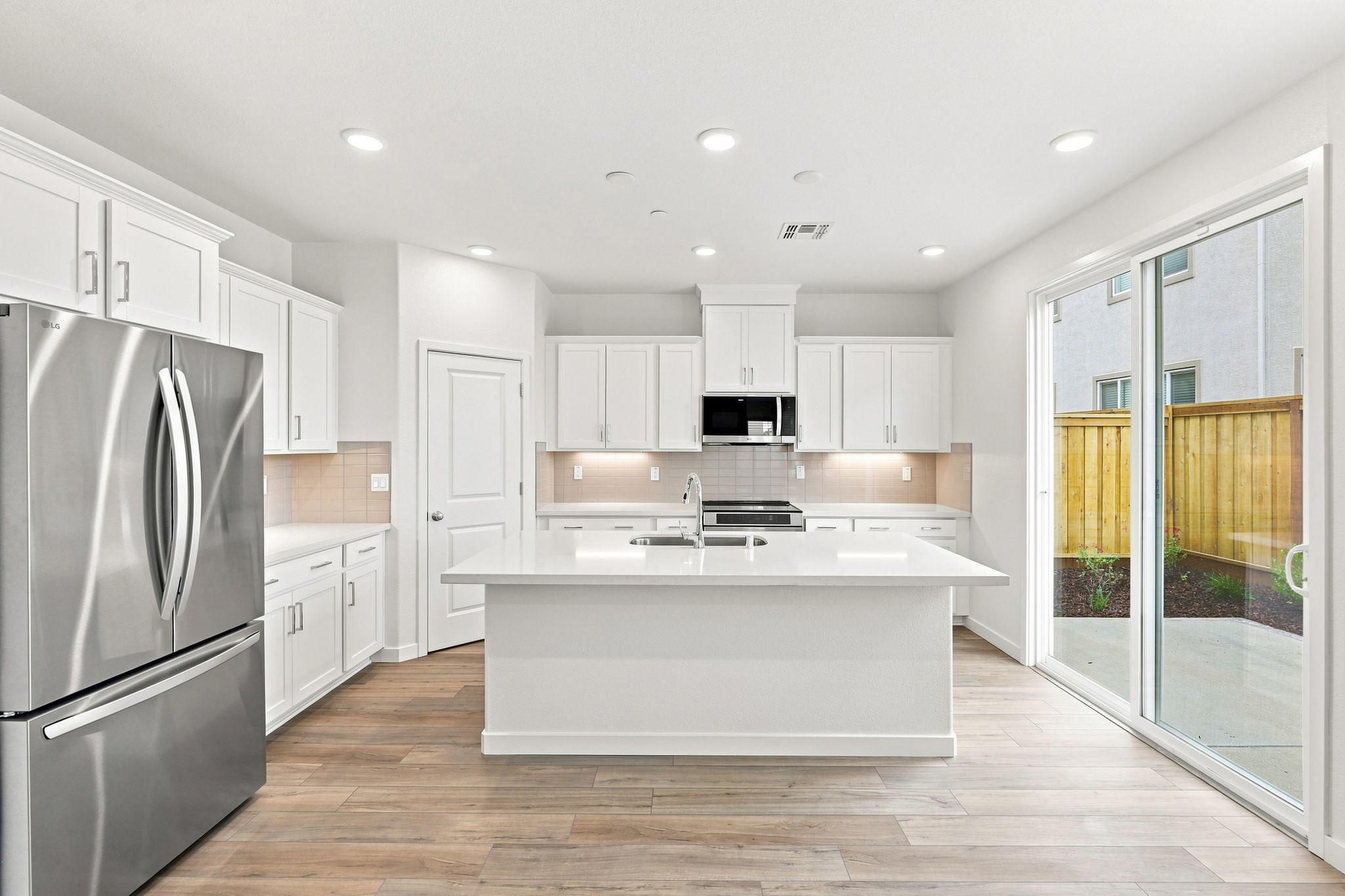 A kitchen with white cabinets.