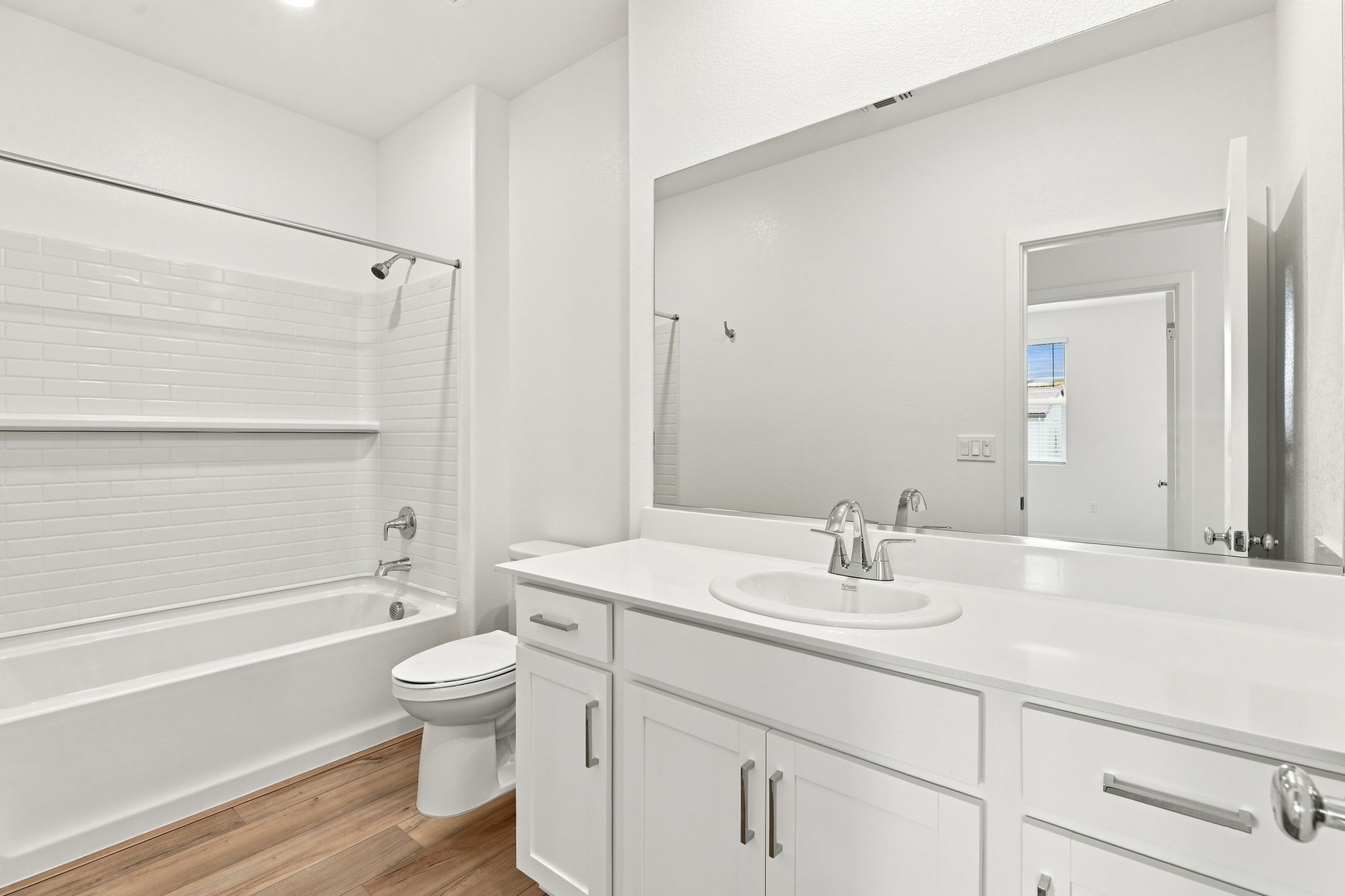 A bathroom with a tub sink and toilet.