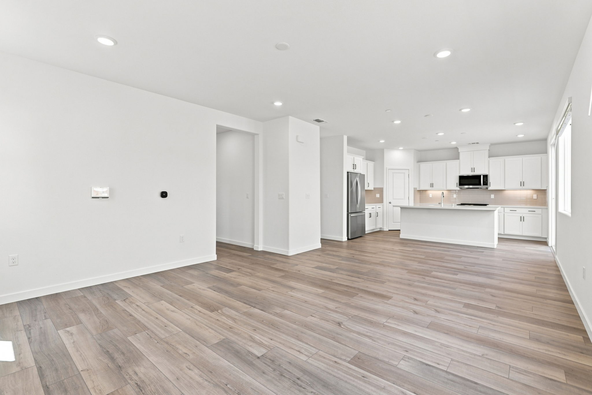 A kitchen with white cabinets.