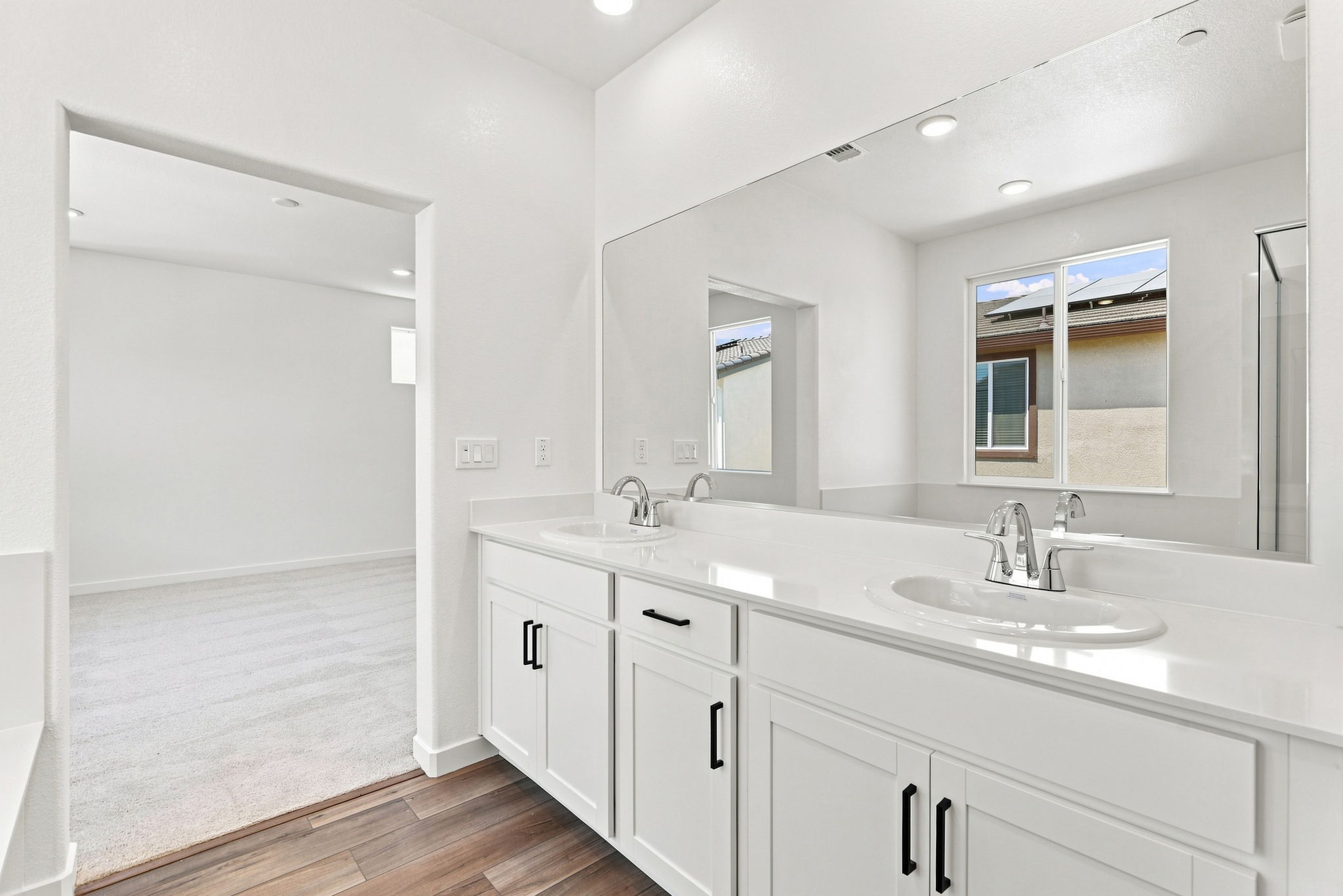 A bathroom with a large mirror.