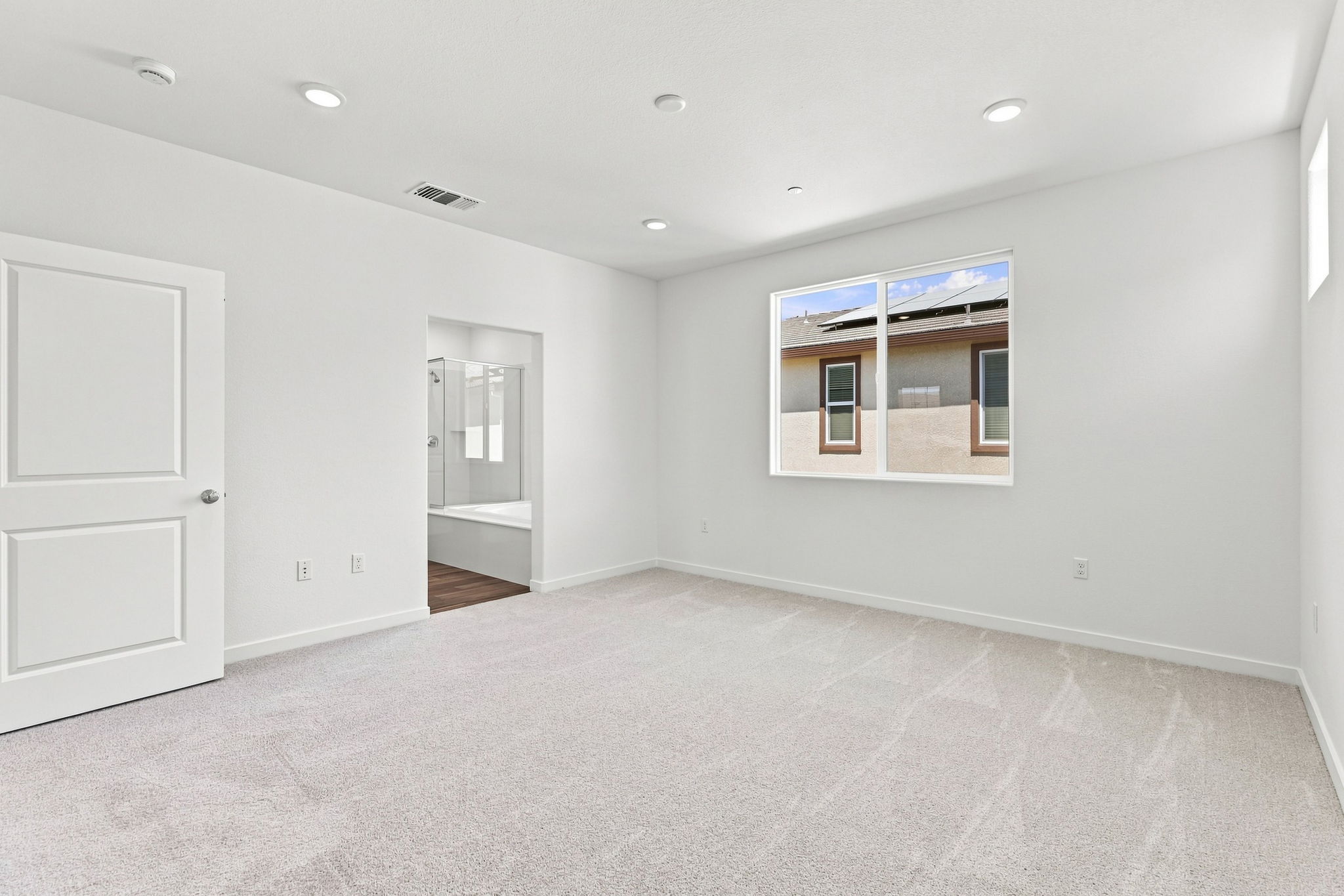 A room with white walls and a window.