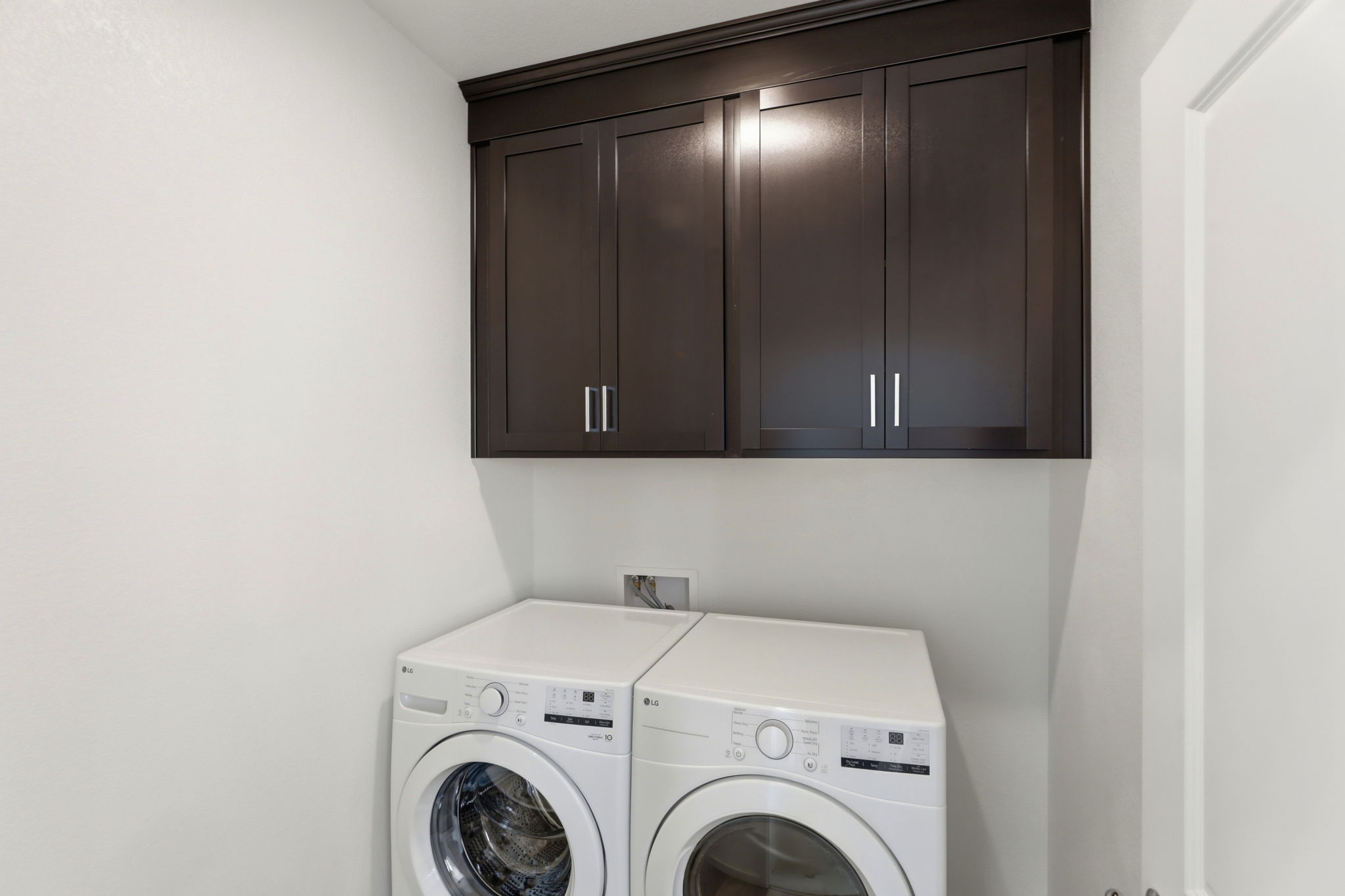 A washing machine and dryer in a room.