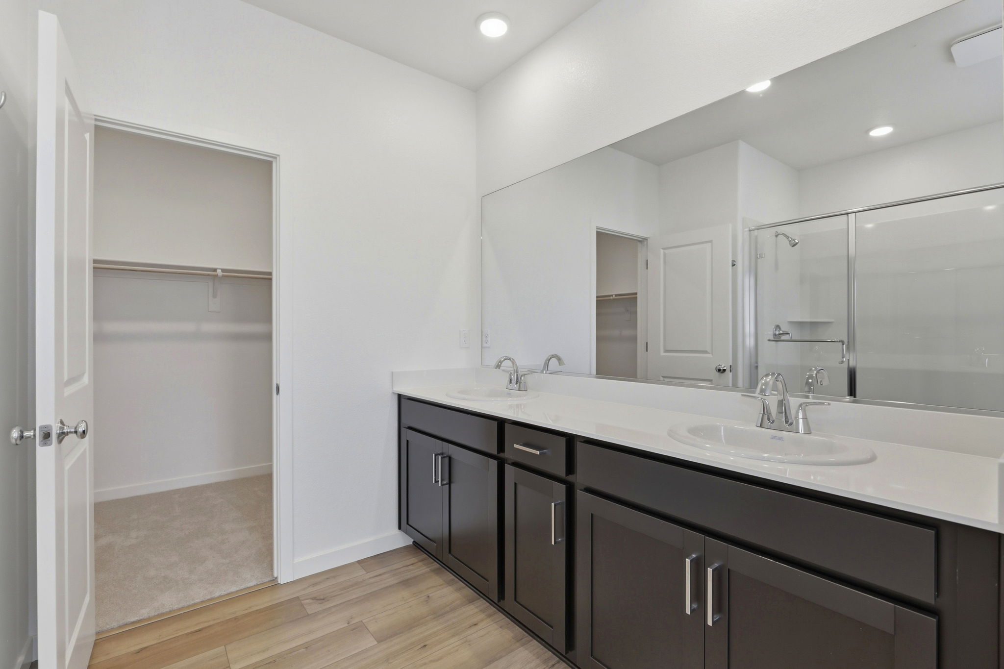 A bathroom with a large mirror.