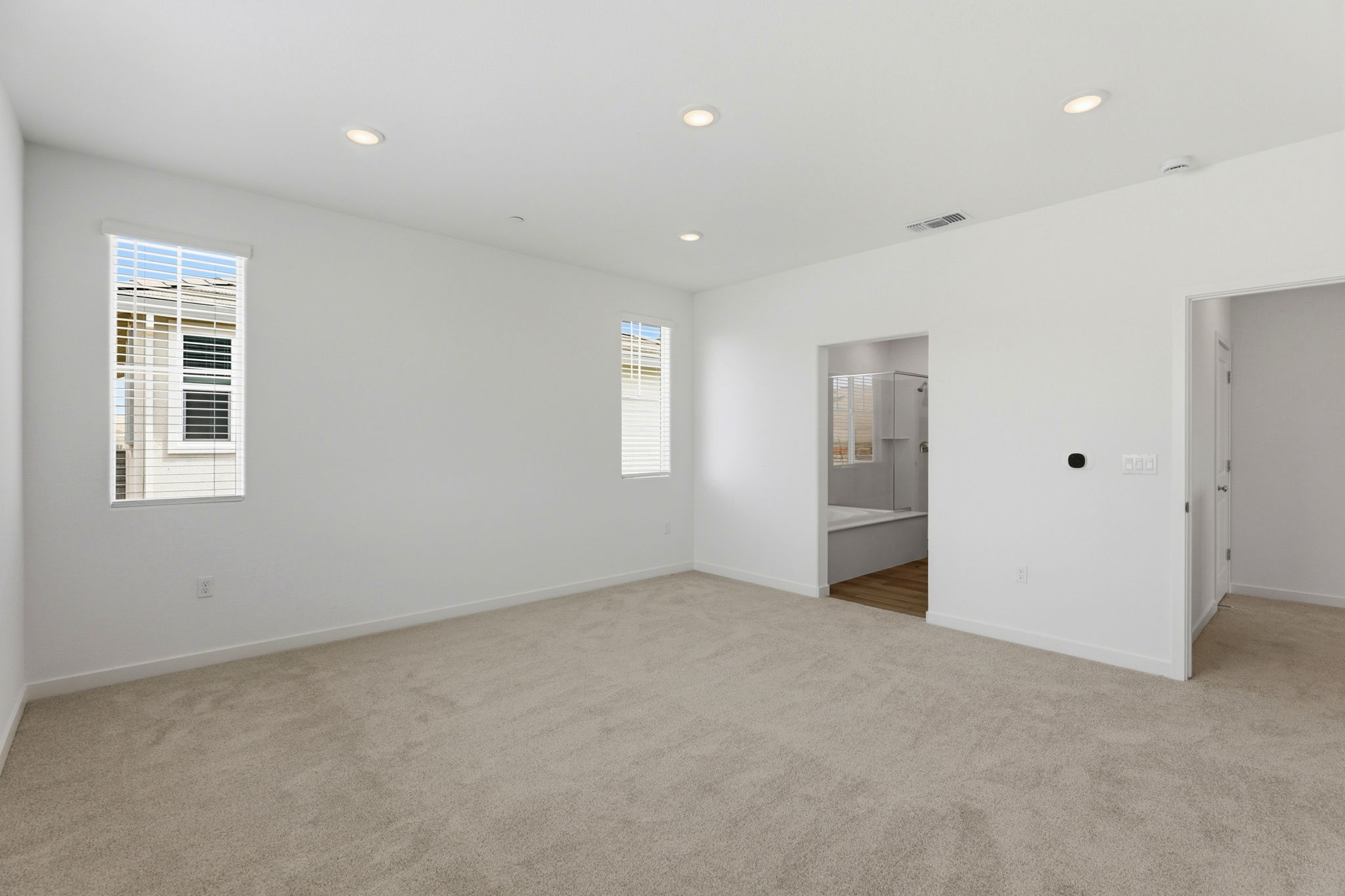 A room with a carpet and a door.