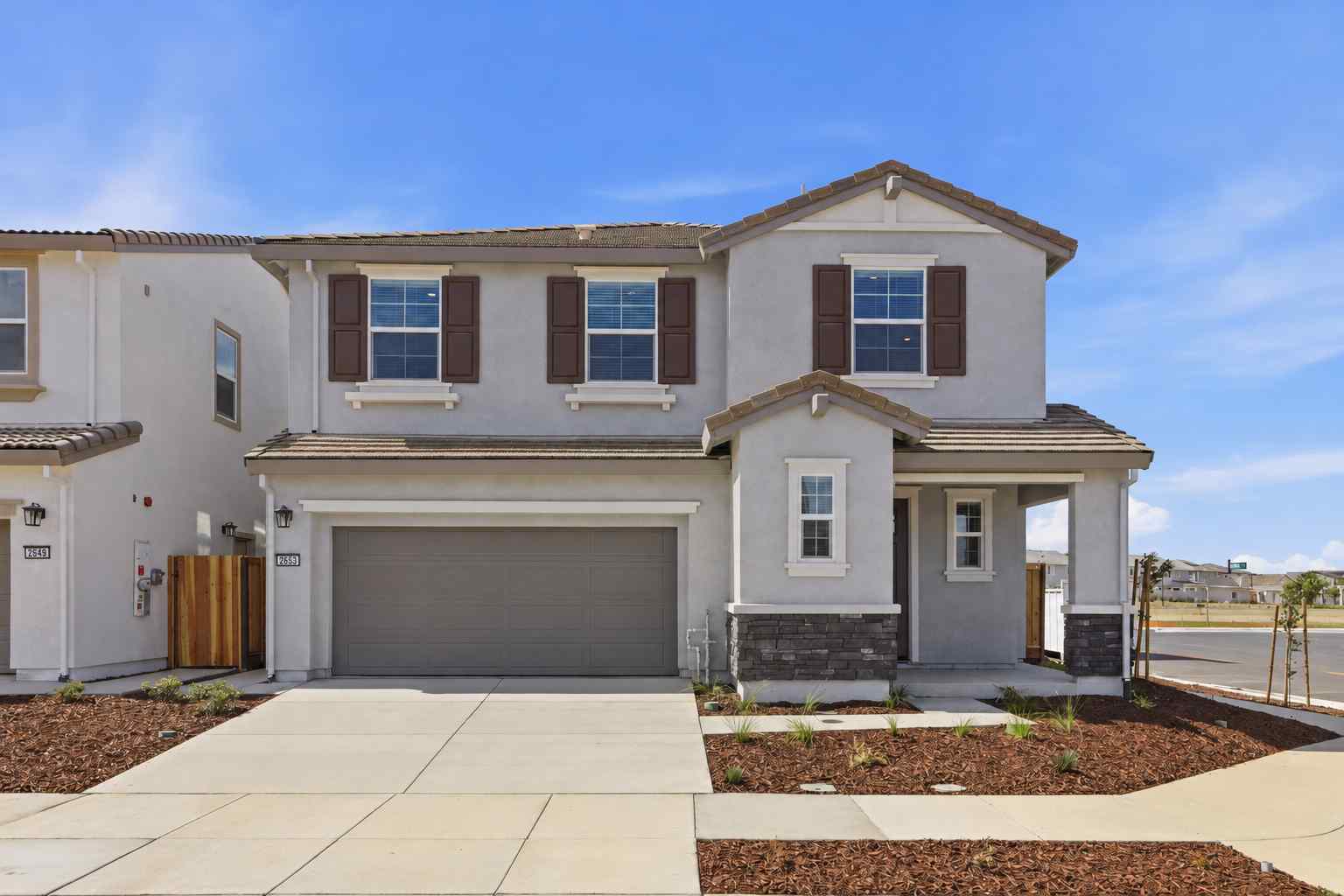 A white house with a garage.