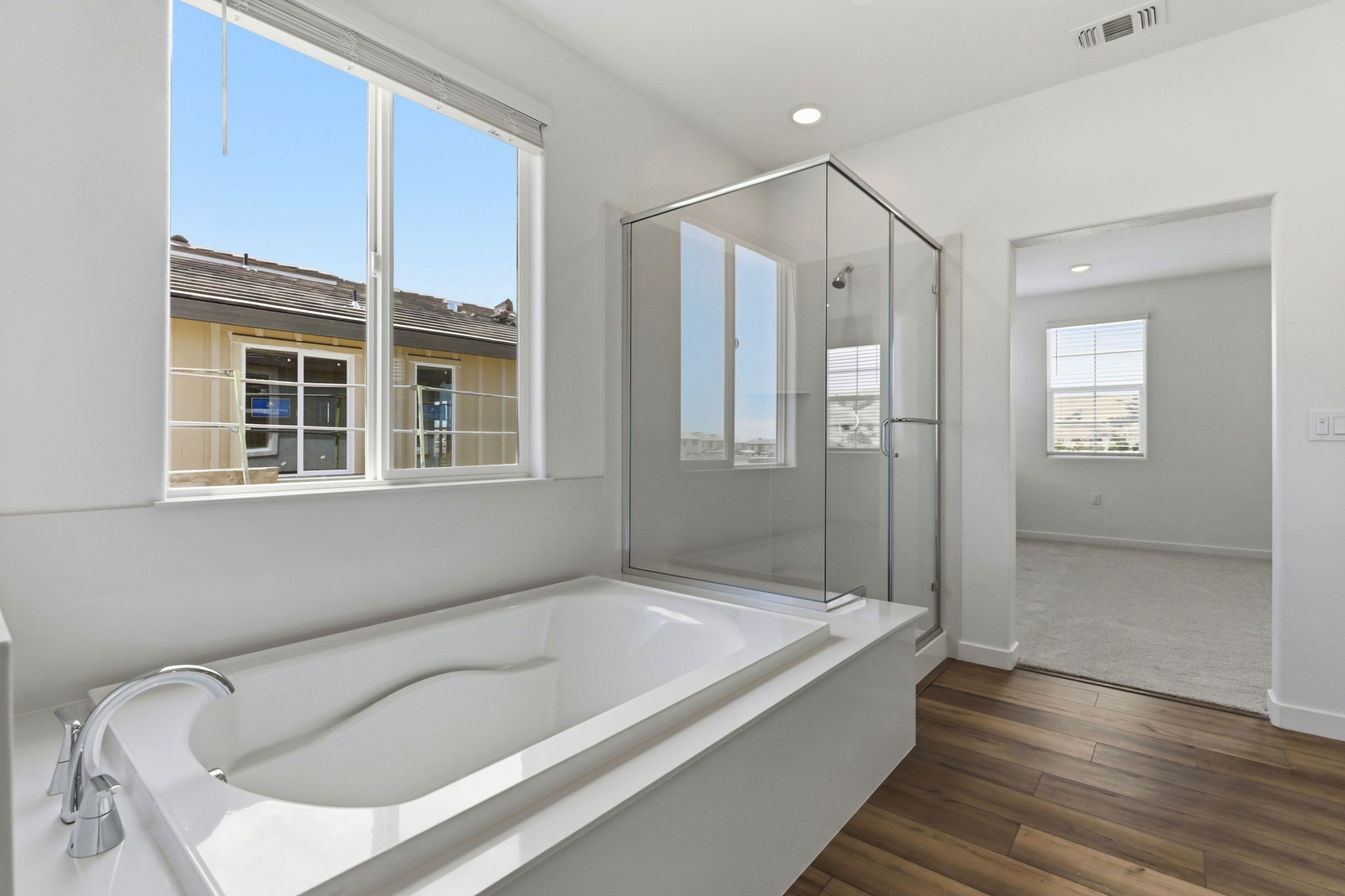 A bathroom with a tub and a window.