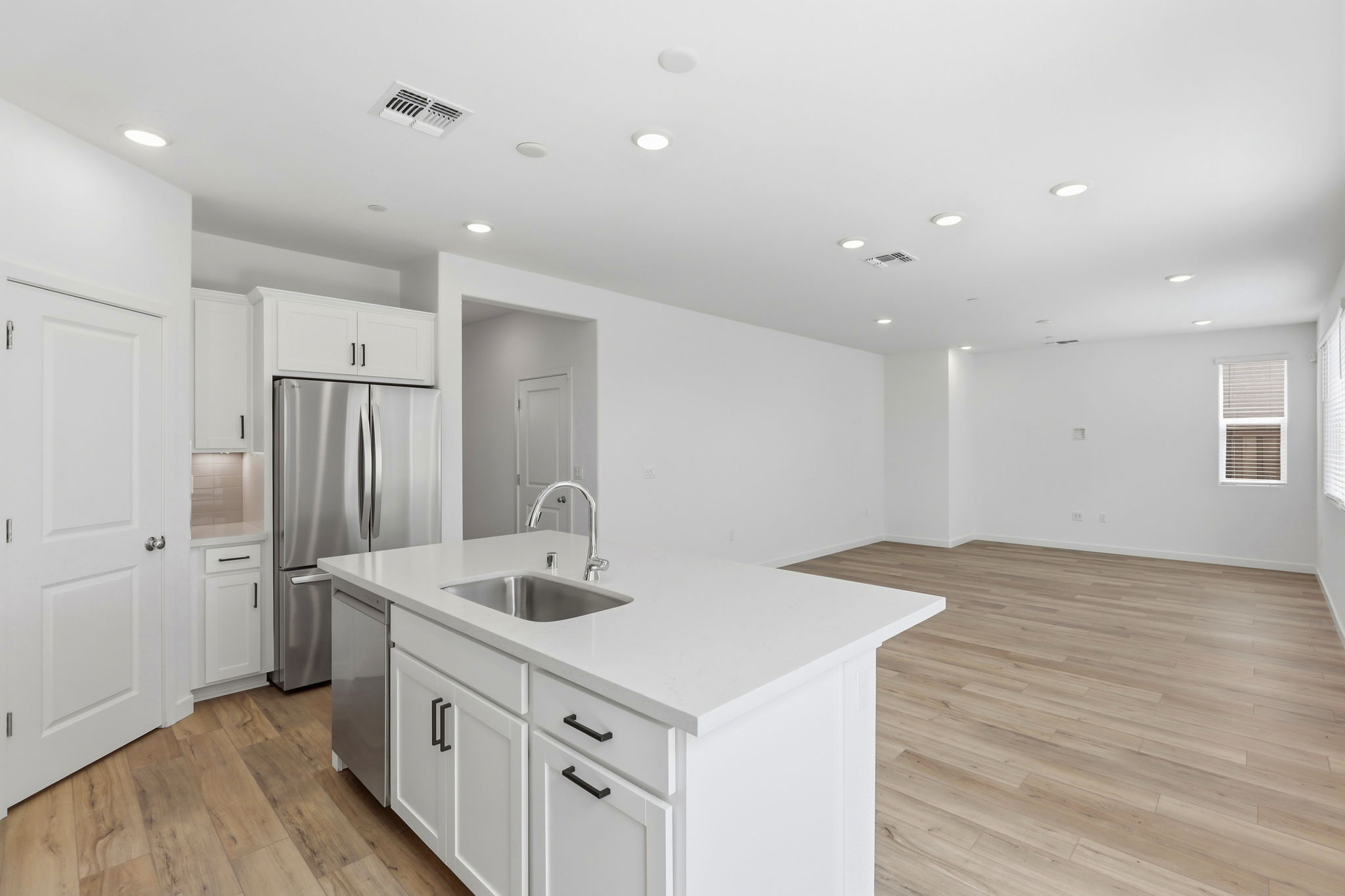 A kitchen with white cabinets.