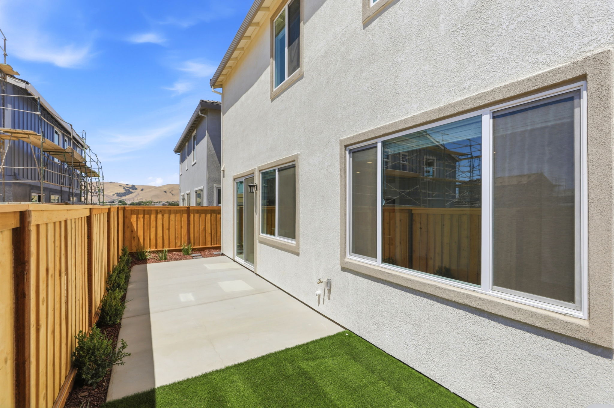 A house with a fence and grass.