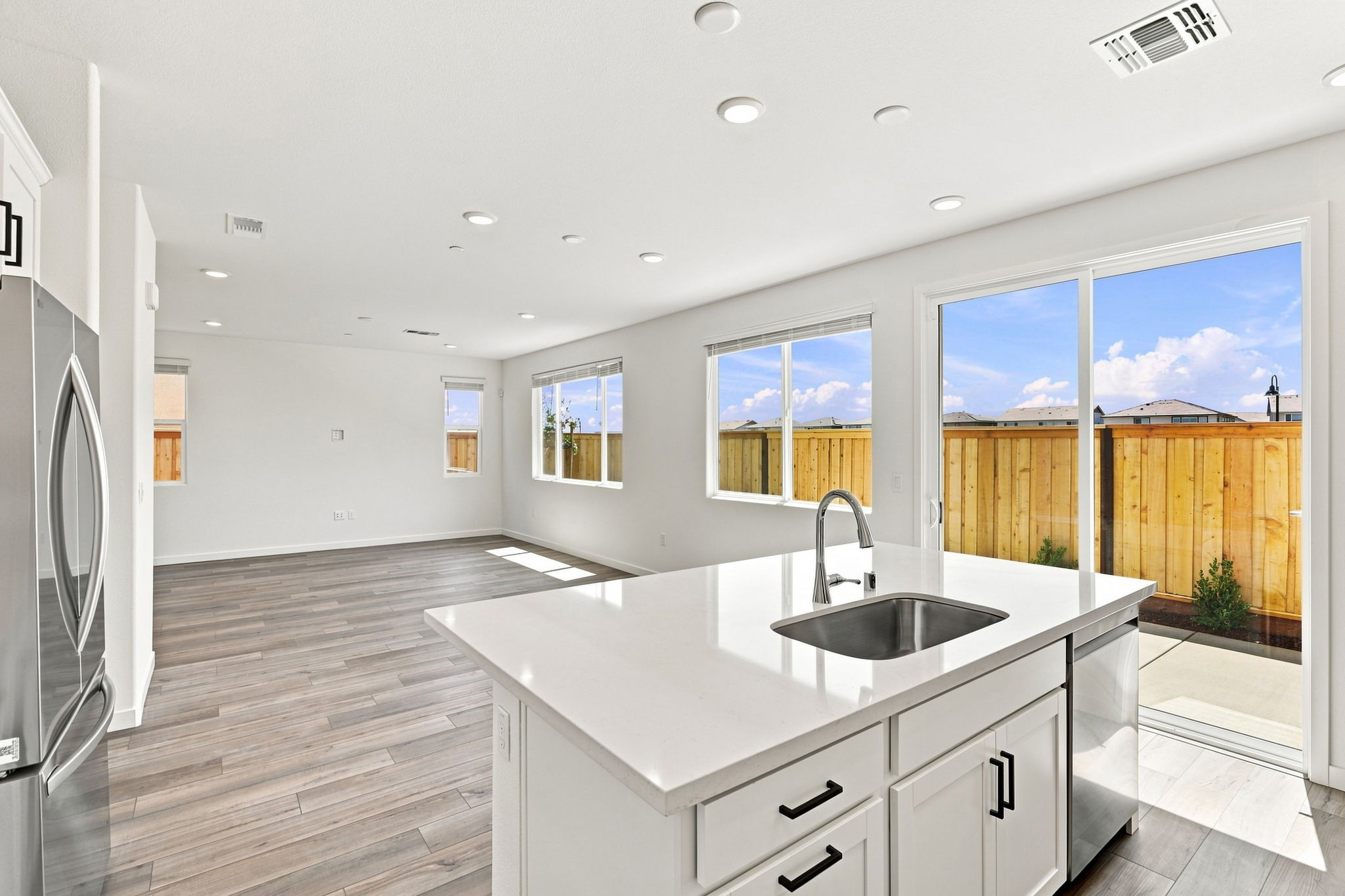A kitchen with a large window.