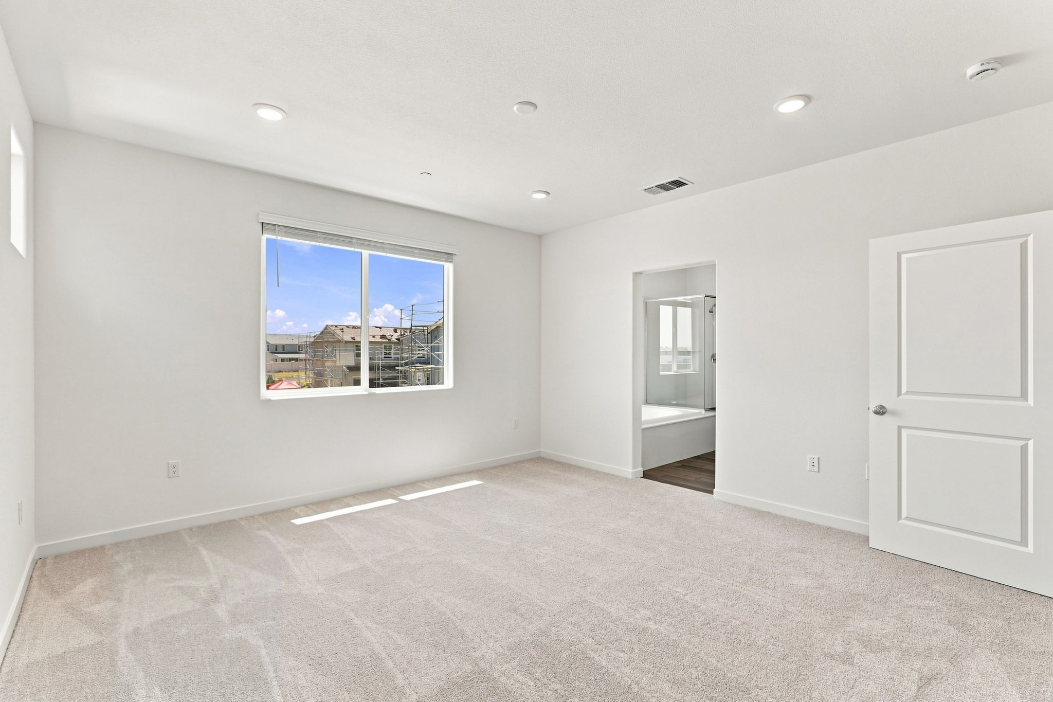 A room with a window and a door.
