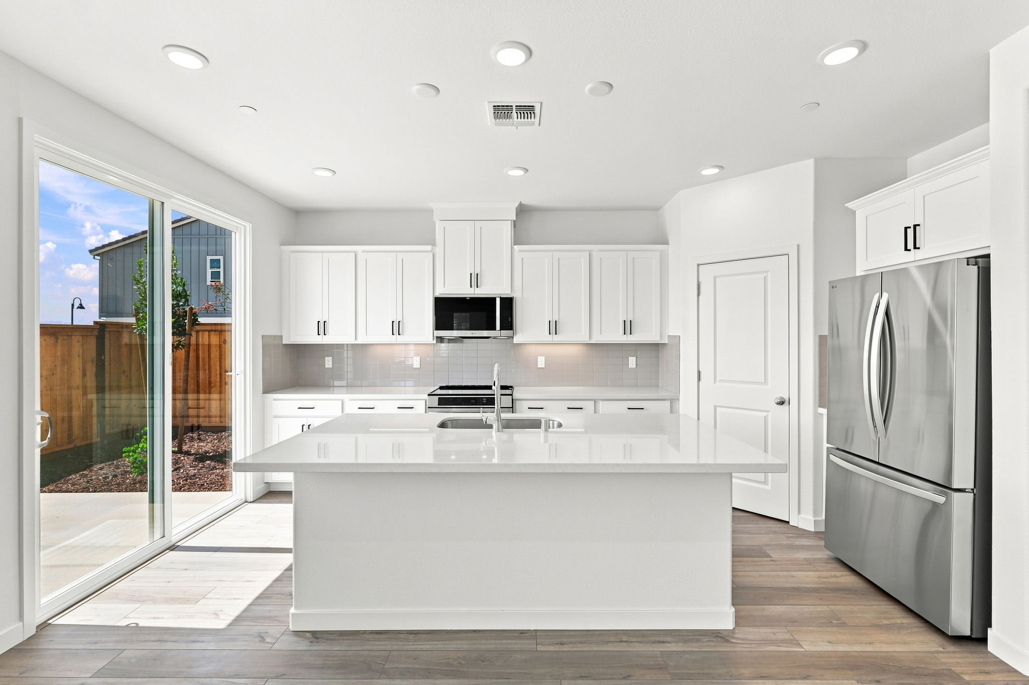 A kitchen with white cabinets.