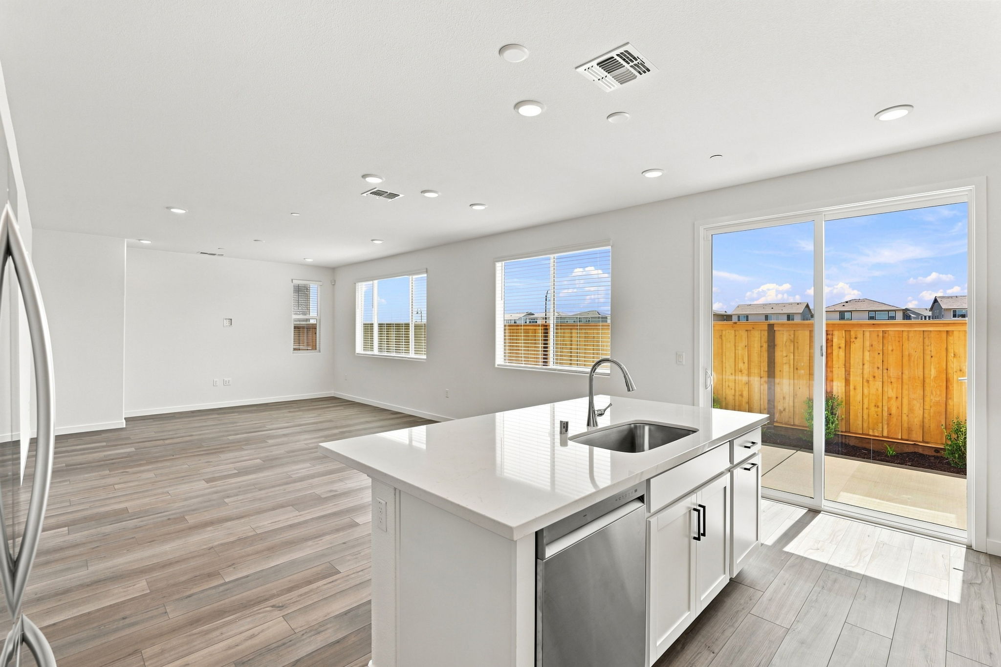 A kitchen with a large window.
