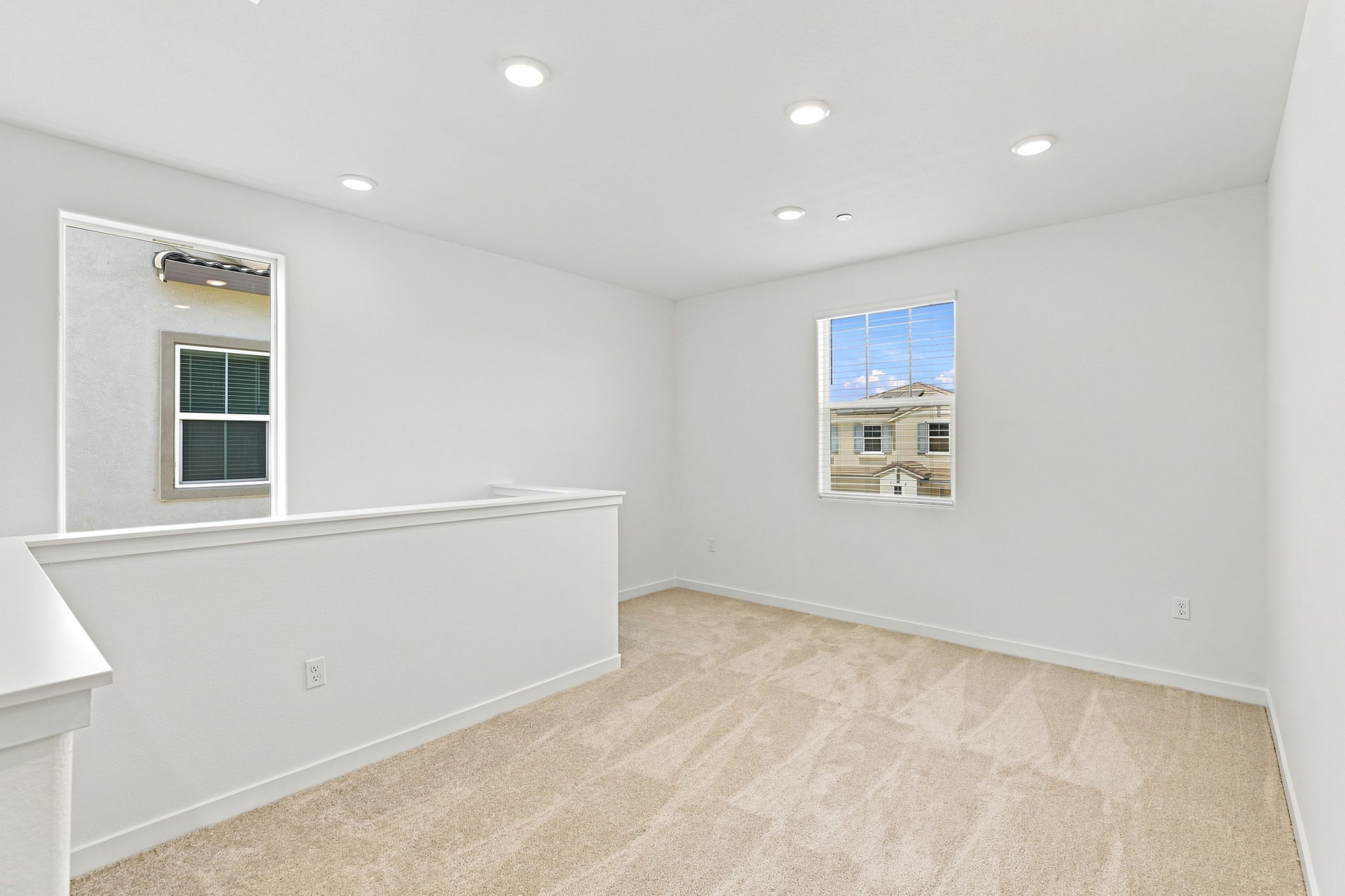 A room with a white wall and a window.