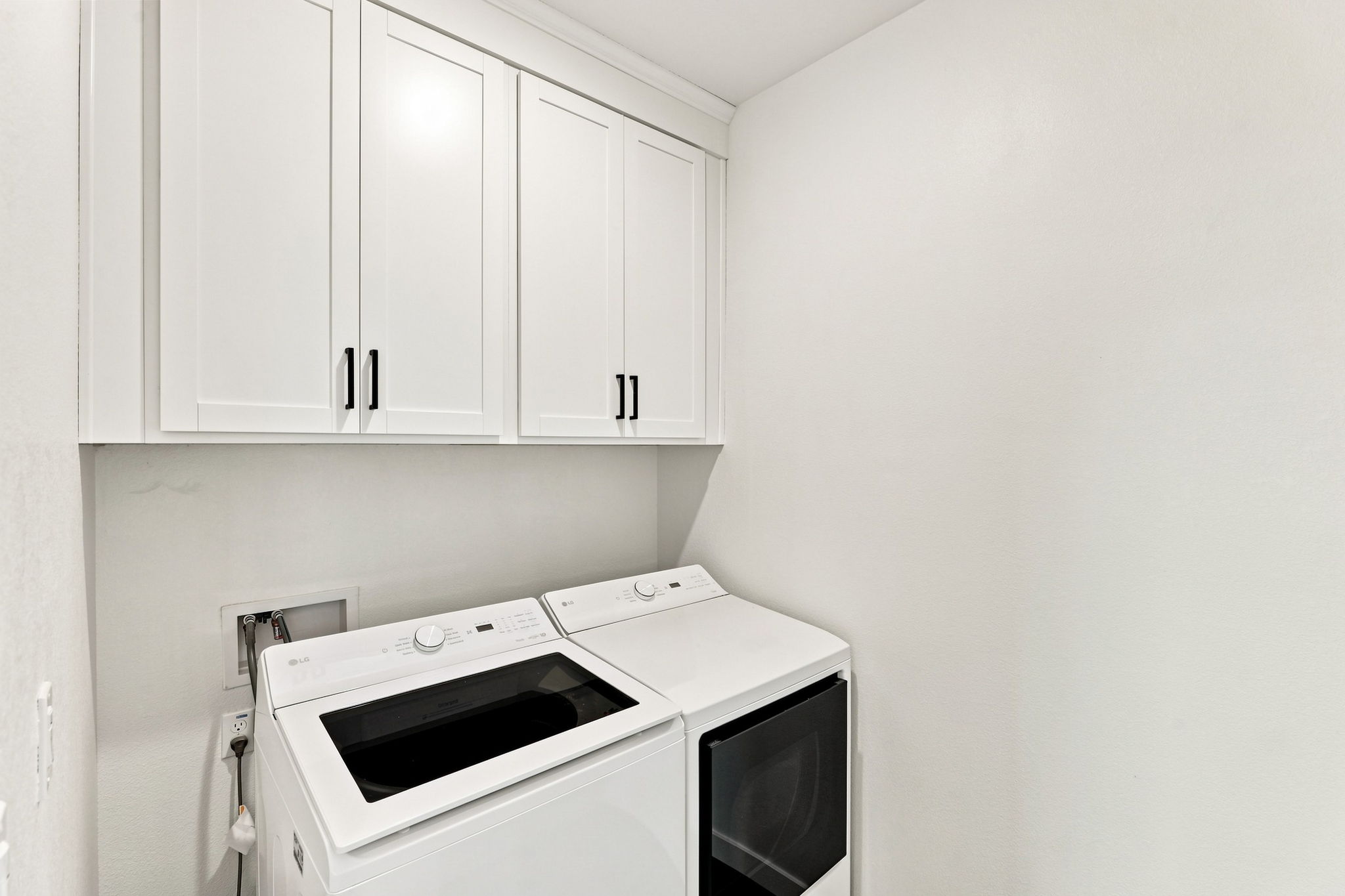 A white kitchen with white cabinets.
