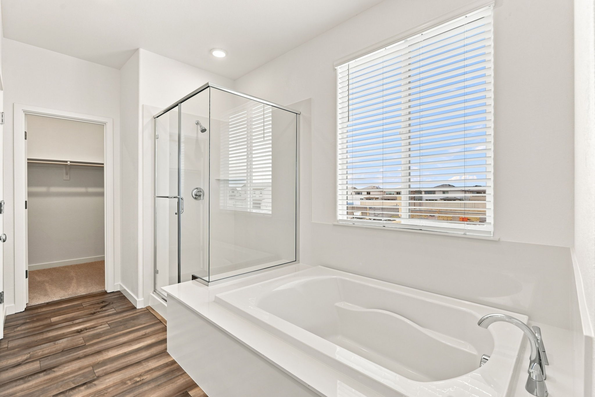 A bathroom with a tub and a shower.