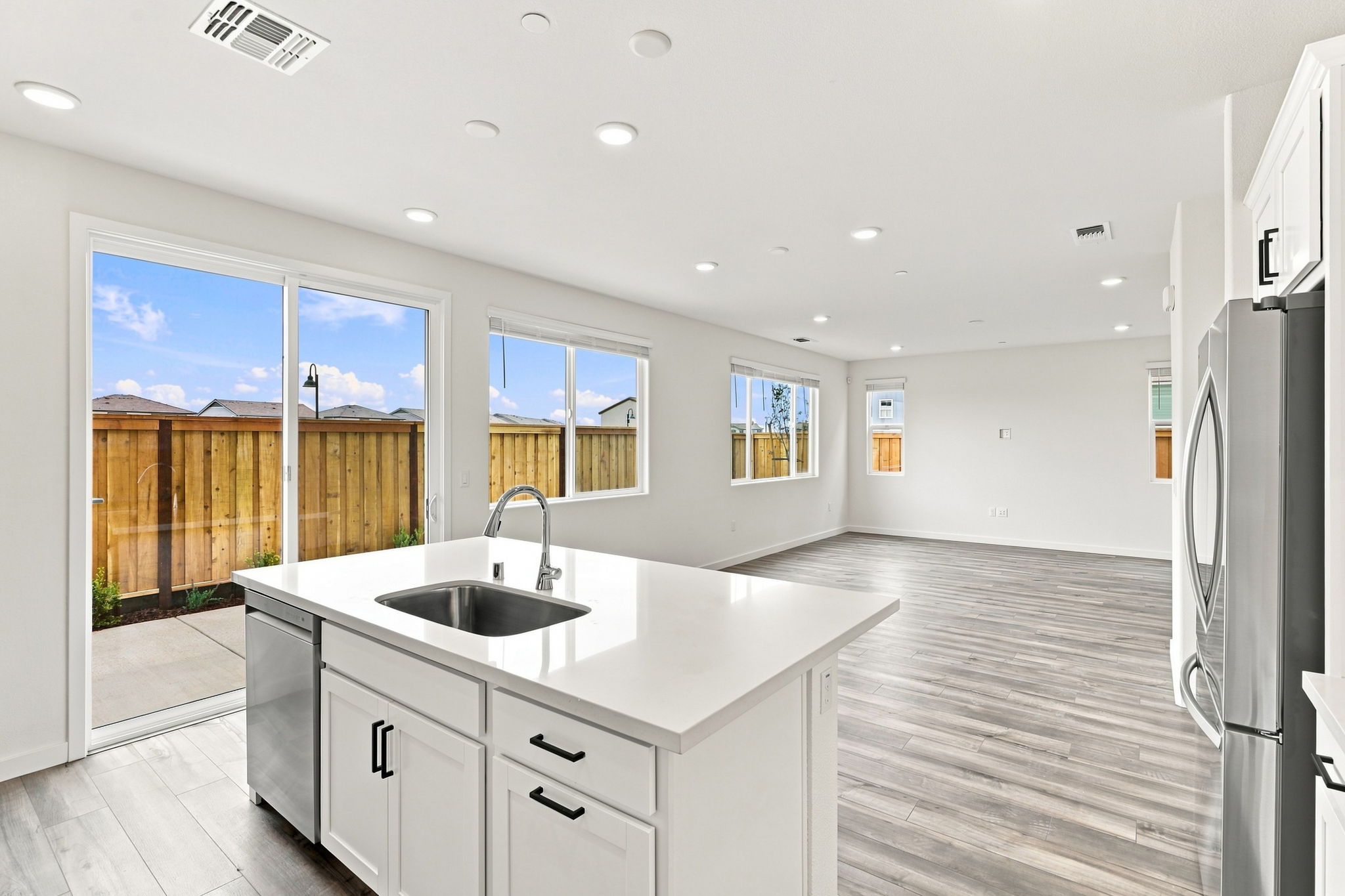 A kitchen with a large window.