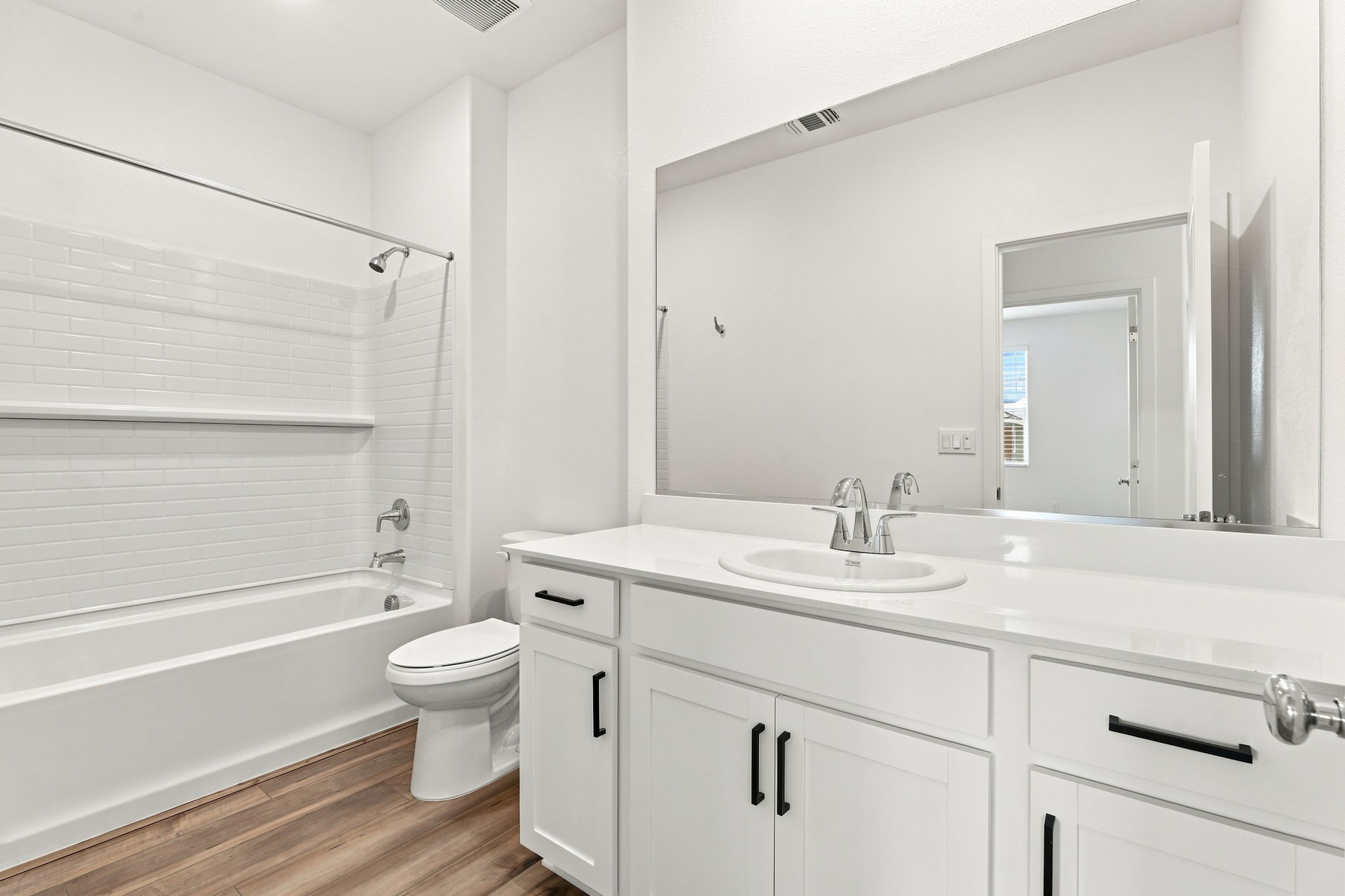 A bathroom with a tub sink and toilet.