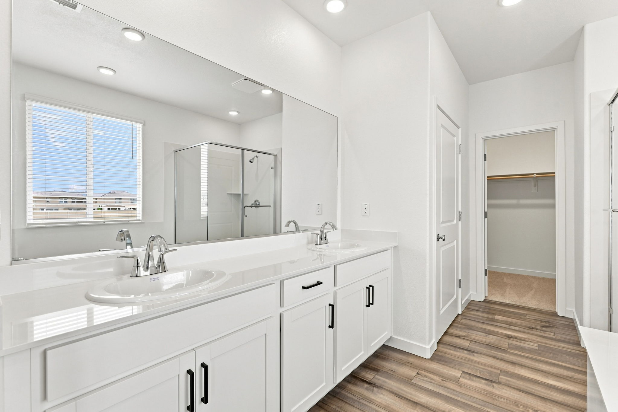 A bathroom with white cabinets.