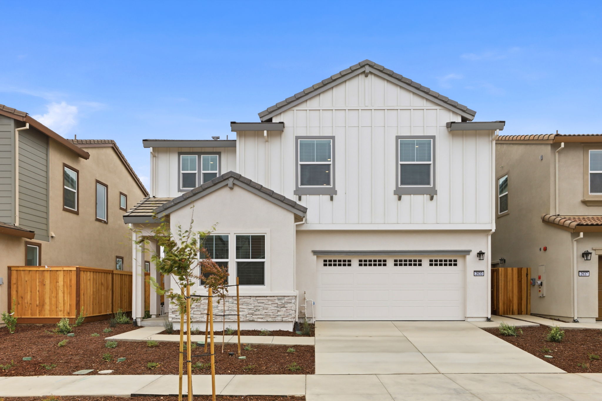 A white house with a garage.