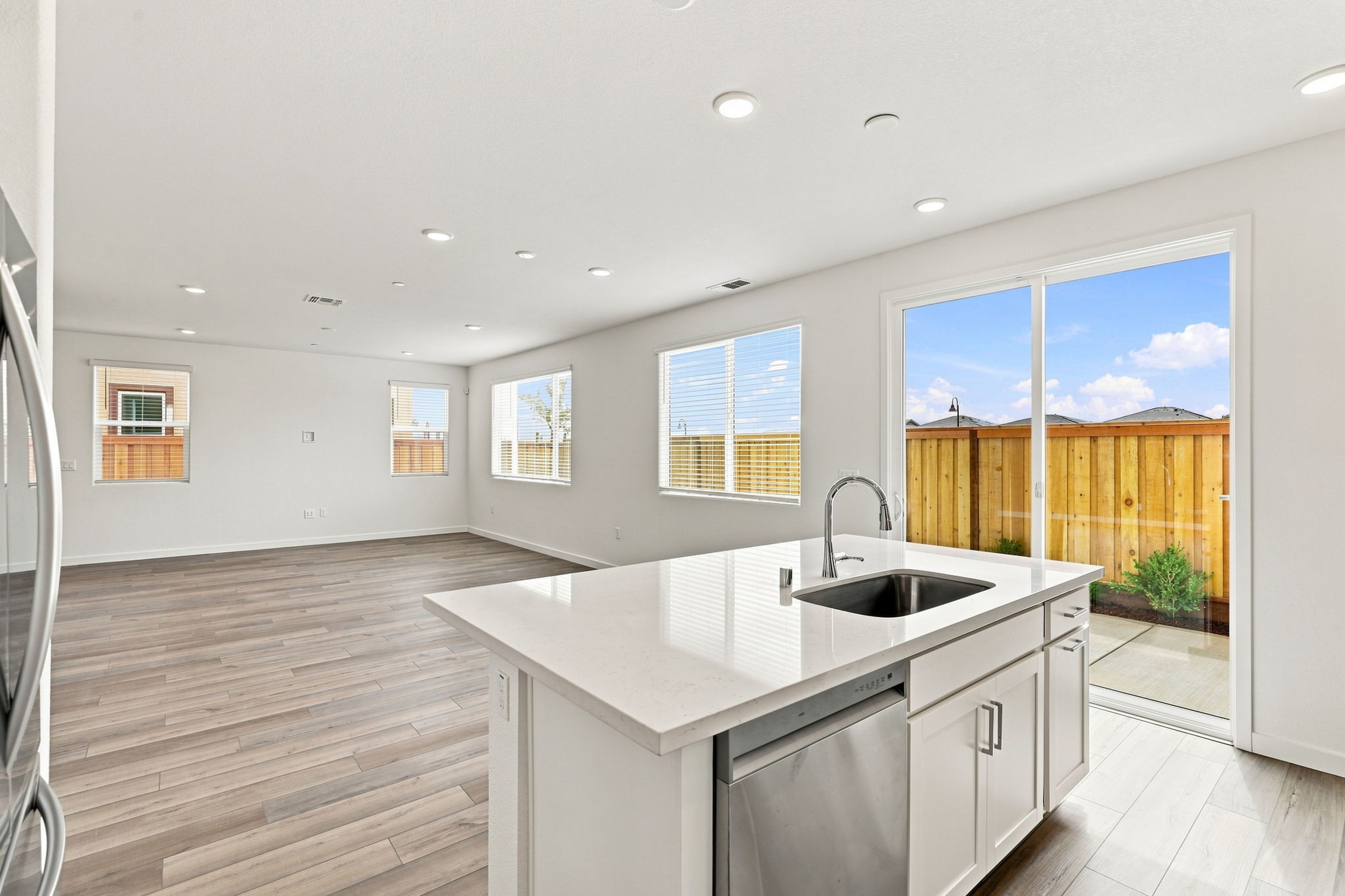 A kitchen with a large window.