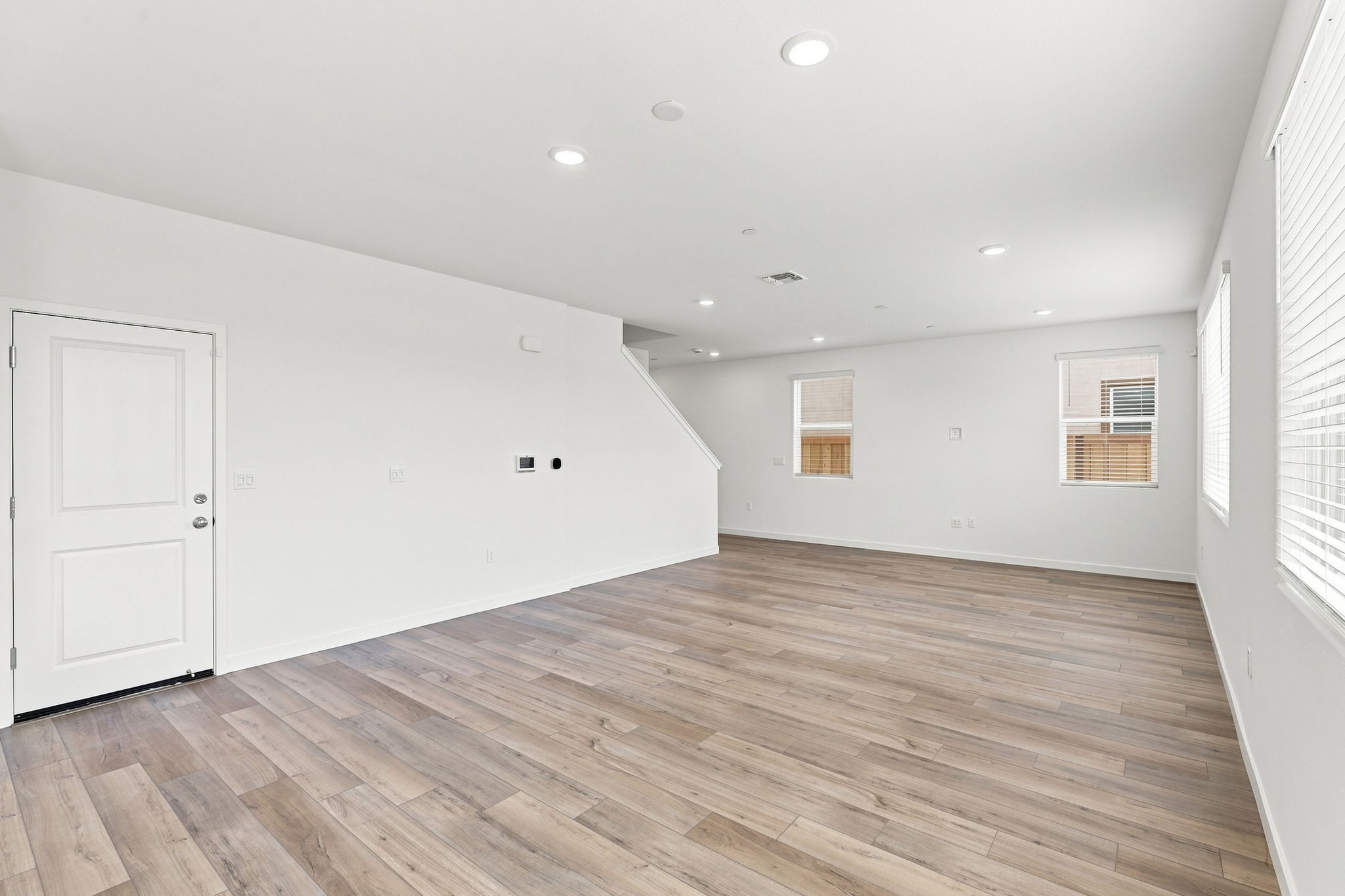 A room with a wood floor and white walls.