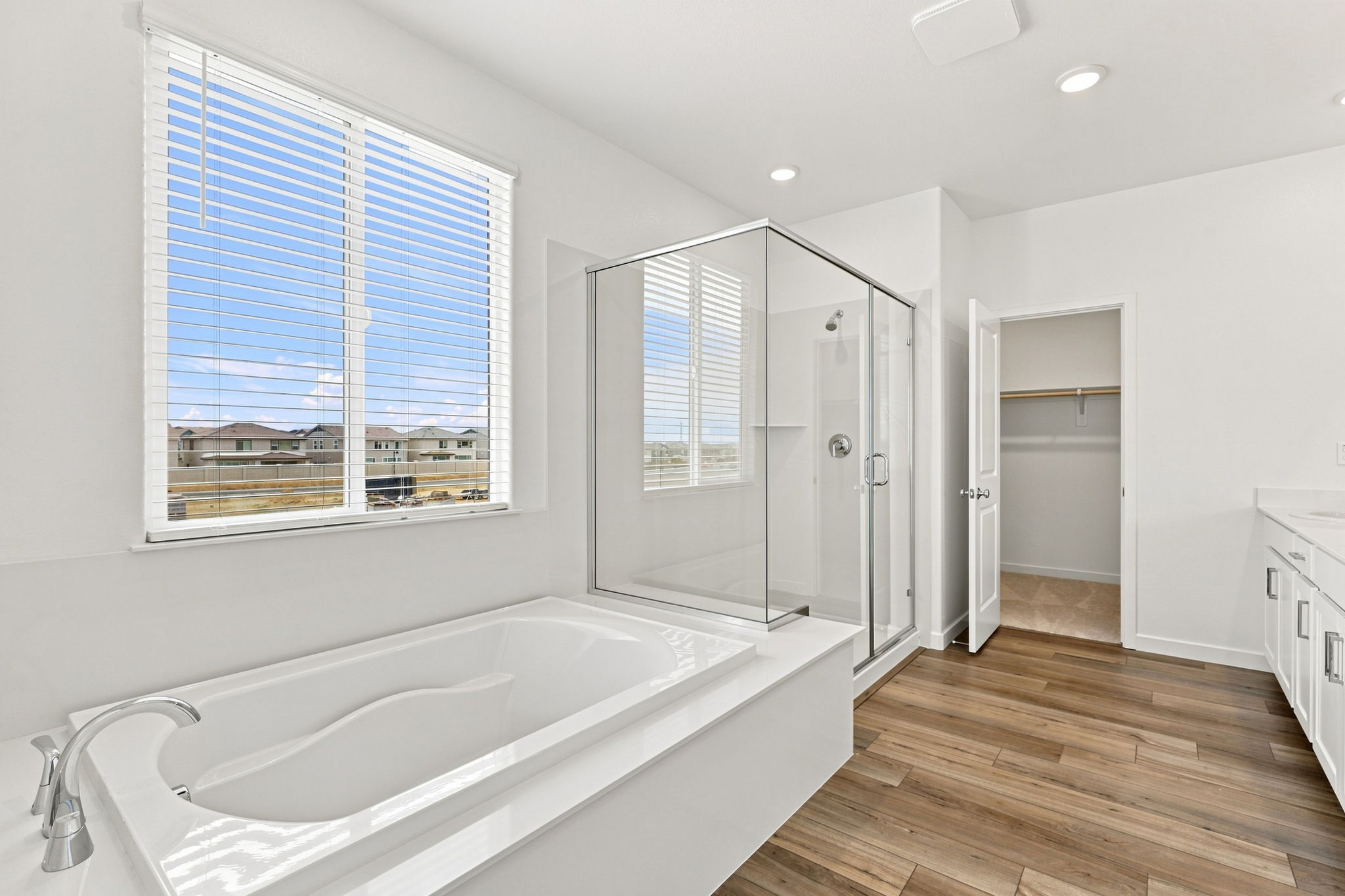 A bathroom with a tub and a shower.