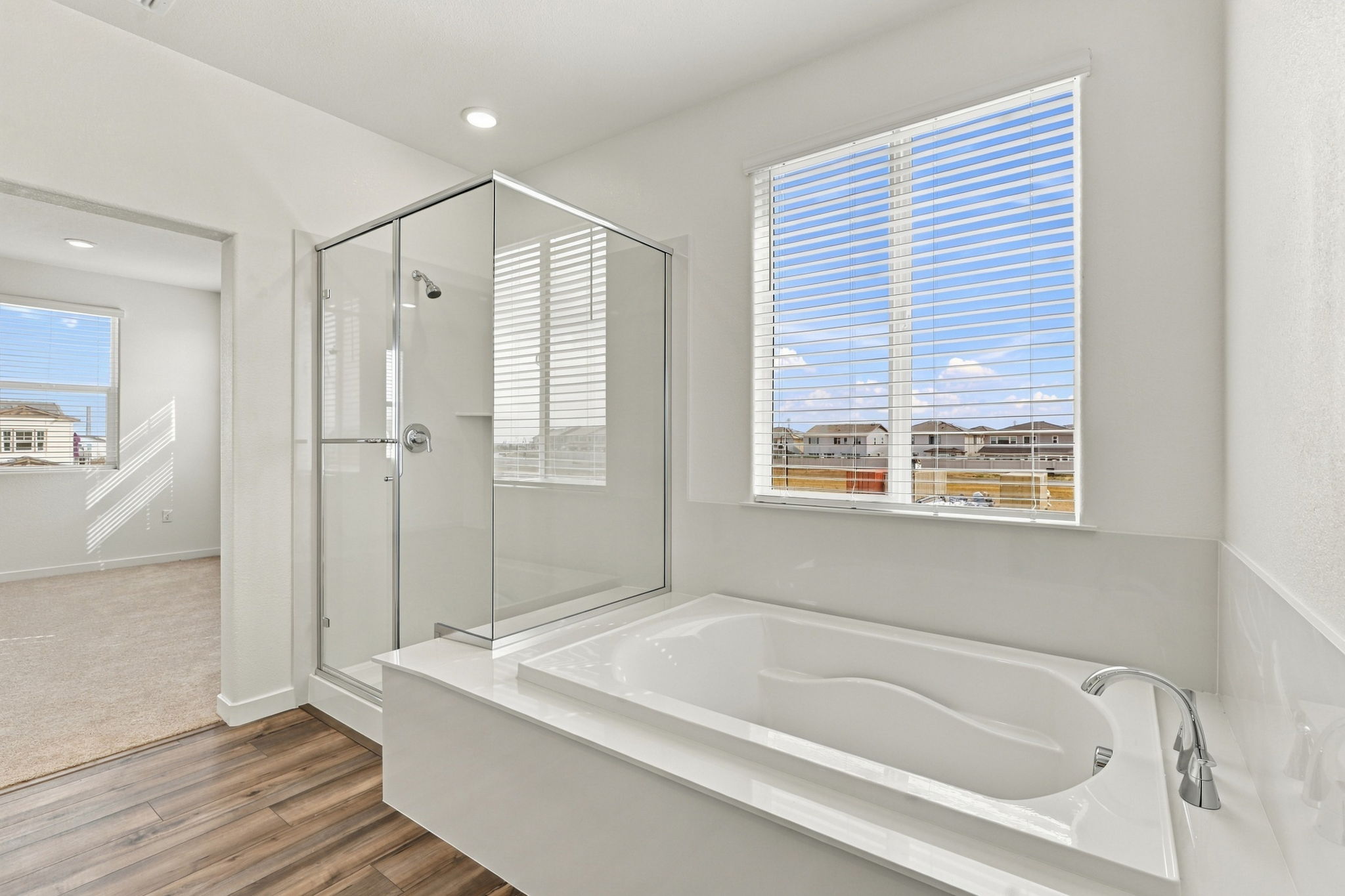A bathroom with a tub and a window.