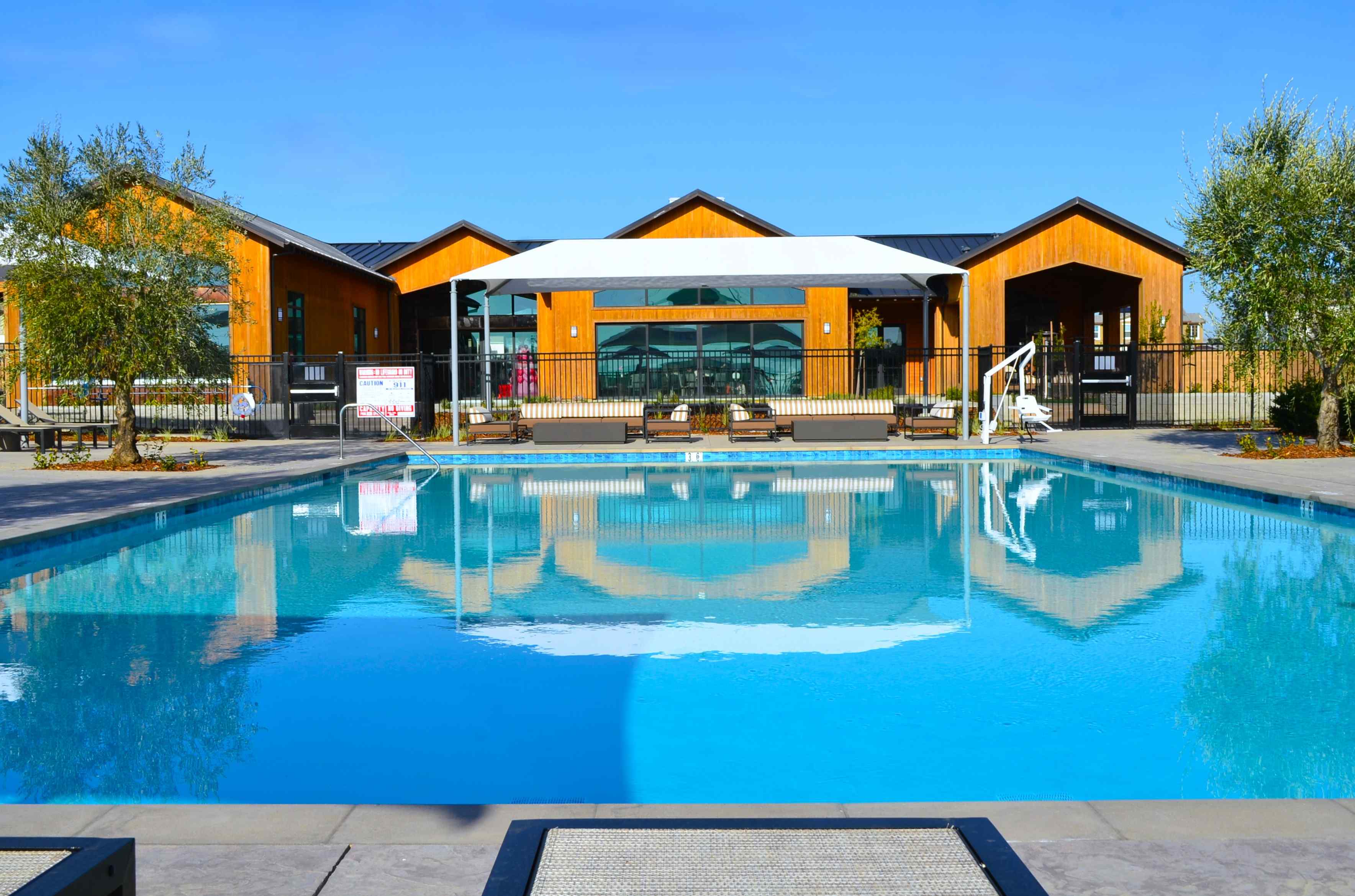 A swimming pool in front of a house.