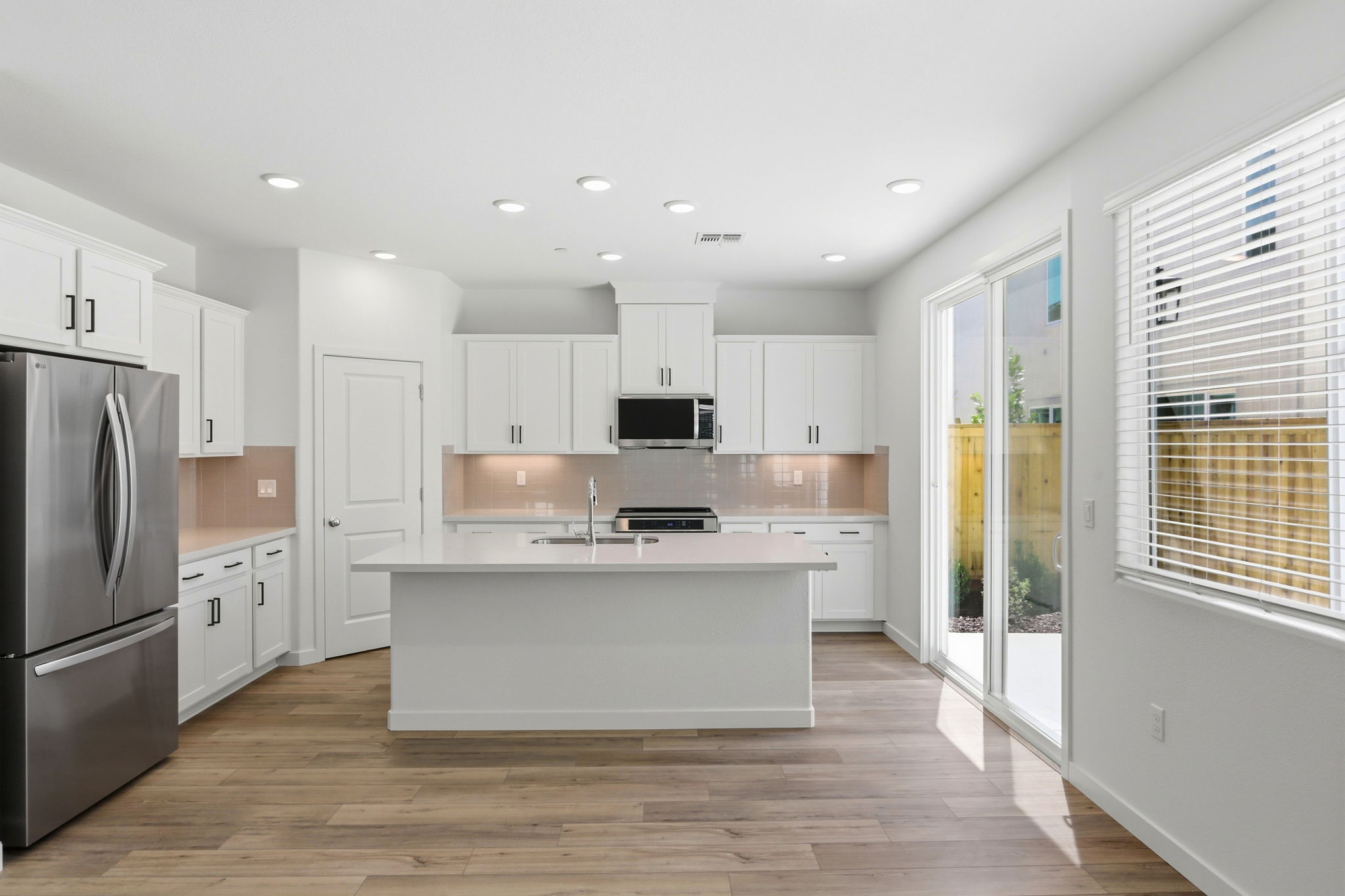 A kitchen with white cabinets.